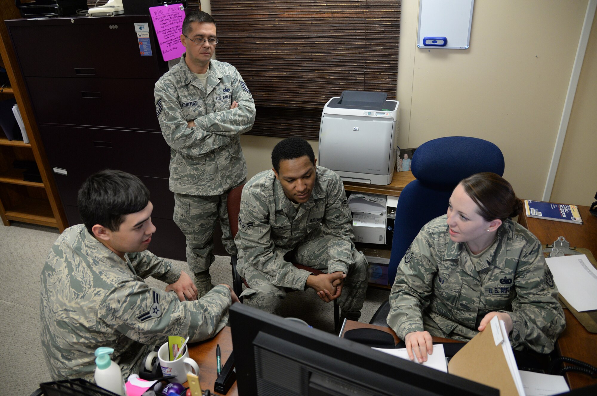 U.S. Air Force Staff Sgt. Rachel Tiu, the 354th Logistics Readiness Squadron NCO in-charge of inventory, conducts research with the Airmen and an NCO in her shop, Sept. 1, 2015, at Eielson Air Force Base, Alaska. Tiu and her Airmen research assets when they are out of balance and analyze trends for problematic conditions. (U.S. Air Force photo by Airman 1st Class Cassandra Whitman/Released)