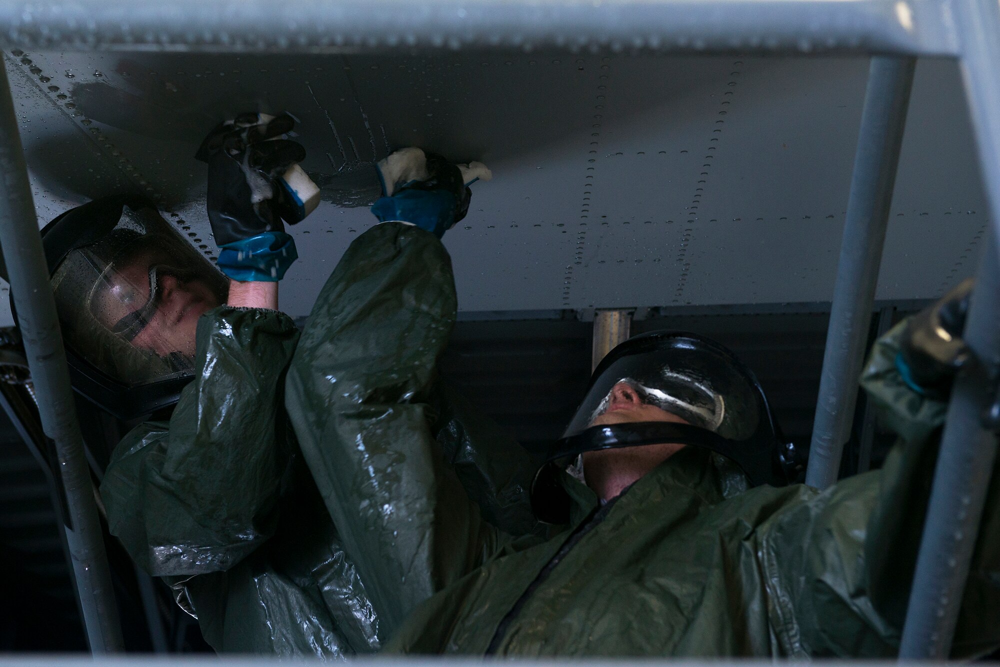 U.S. Air Force Airmen 1st Class Jonathan Brace (left), 71st Rescue Squadron crew chief, and Jacob Vanderwall, 71st RQS navigation communicator, wash an HC-130J Combat King II’s wing Sept. 1, 2015, at Moody Air Force Base, Ga. Airmen are required to wear wash suits while cleaning the aircraft to avoid getting soap and water on them. (U.S. Air Force photo by Airman 1st Class Kathleen D. Bryant/Released)
