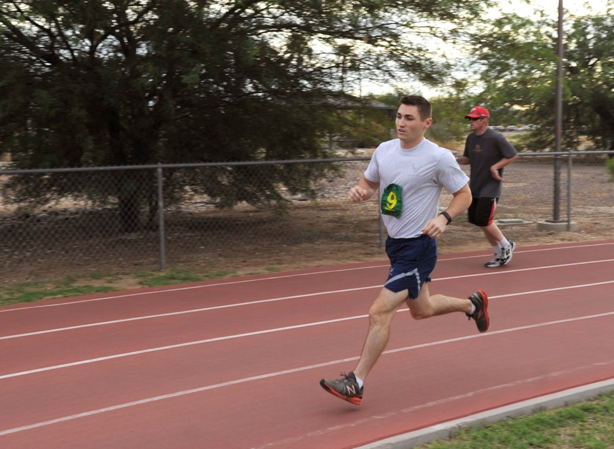 U.S. Air Force First Lieutenant Brian Ingham, 42nd Electronic Combat Mission Squadron EC-130H student pilot, performs the 1.5 mile portion of the fitness assessment at Davis-Monthan Air Force Base, Ariz., July 27, 2015. Ingham was first to complete the running portion of this FA. When an Airman scores an absolute 100 percent on the FA, they receive recognition and have their picture displayed in the lobby of the Tech. Sgt. Arthur J. Benko Fitness and Sports Center. (U.S. Air Force photo by Airman 1st Class Mya M. Crosby/Released)