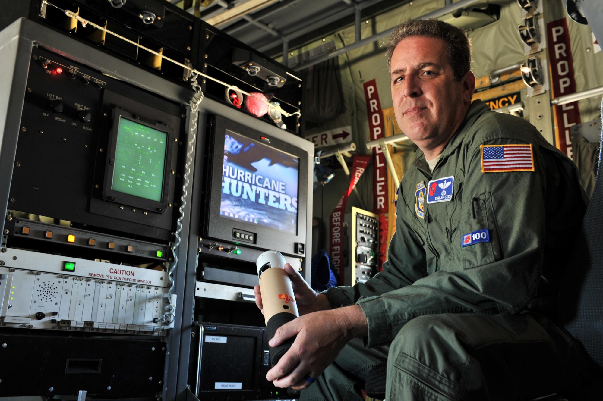 Master Sgt. Jeff Stack, 53rd Weather Reconnaissance Squadron loadmaster, holds a dropsonde while inside a WC-130J, Aug. 26, 2015, Keesler Air Force Base, Miss. Stack flew several missions tracking Hurricane Katrina before it devastated the Gulf Coast. The dropsonde is one of the primary tools the Hurricane Hunters use to accurately track and collect data on tropical storms and hurricanes. (U.S. Air Force photo by Tech. Sgt. Greg C. Biondo)