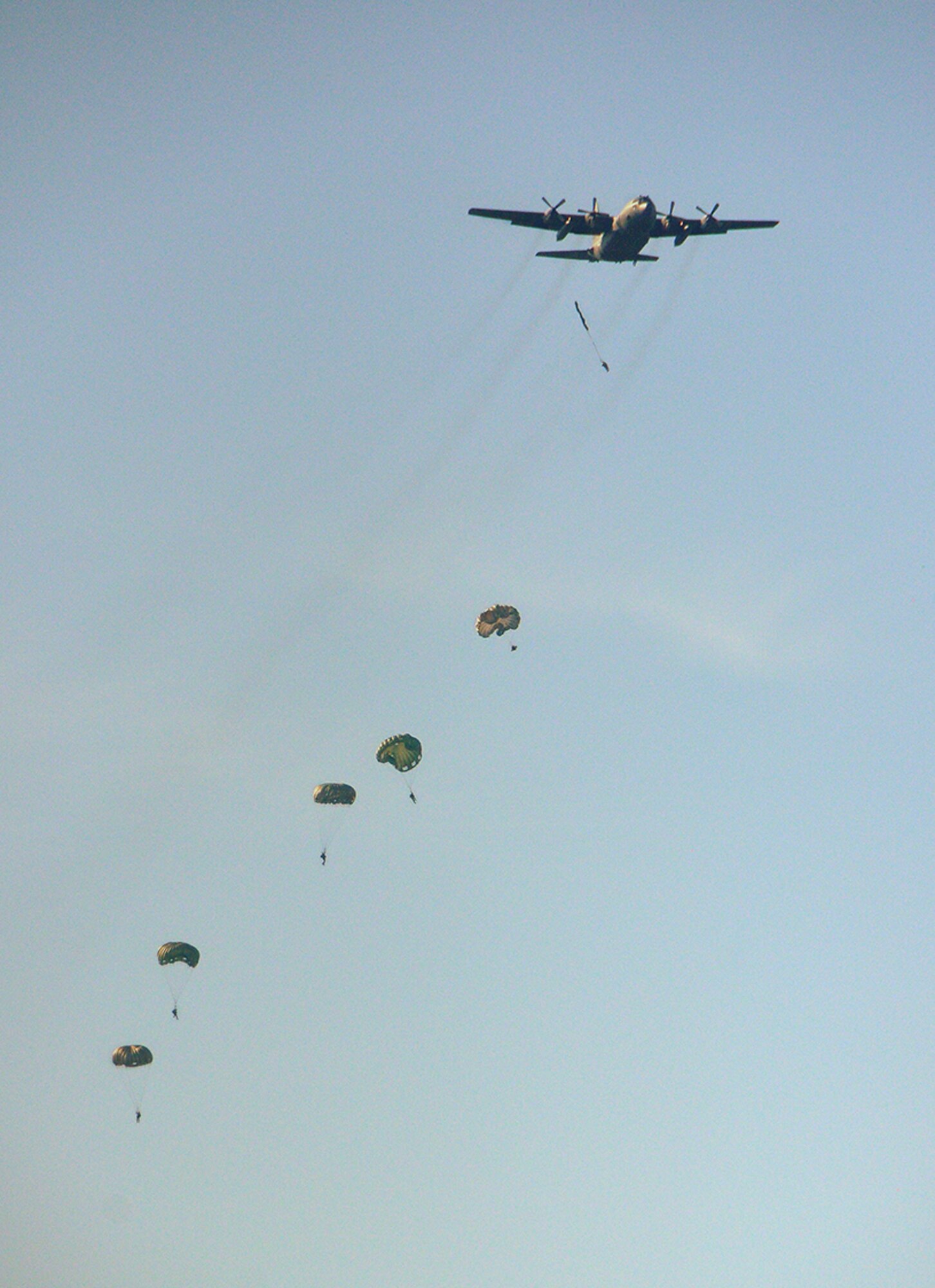 Paratroopers jump from the 908th's C-130. (Photo by Gene H. Hughes)
