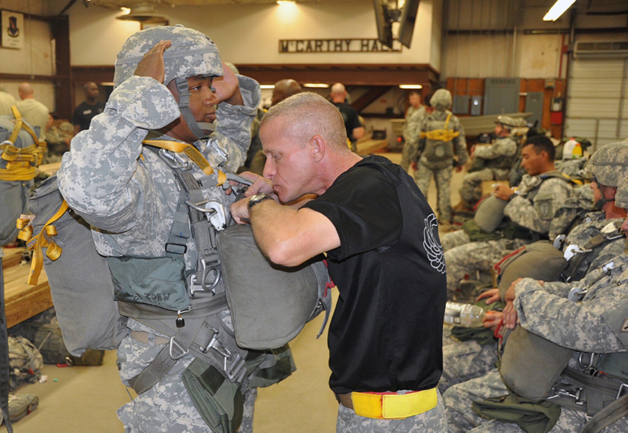 A Basic Airborne School instructor checks a jumper's gear. (Photo by Gene H. Hughes)