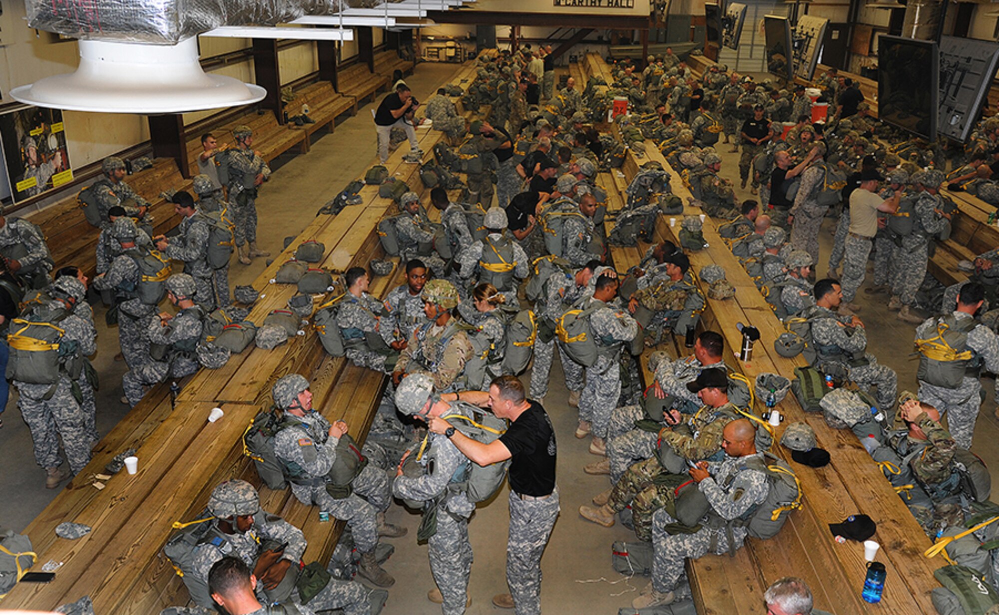 Jump School instructors and Jumpmasters help paratroopers conduct equipment checks. (Photo by Lt. Col. Jerry Lobb)