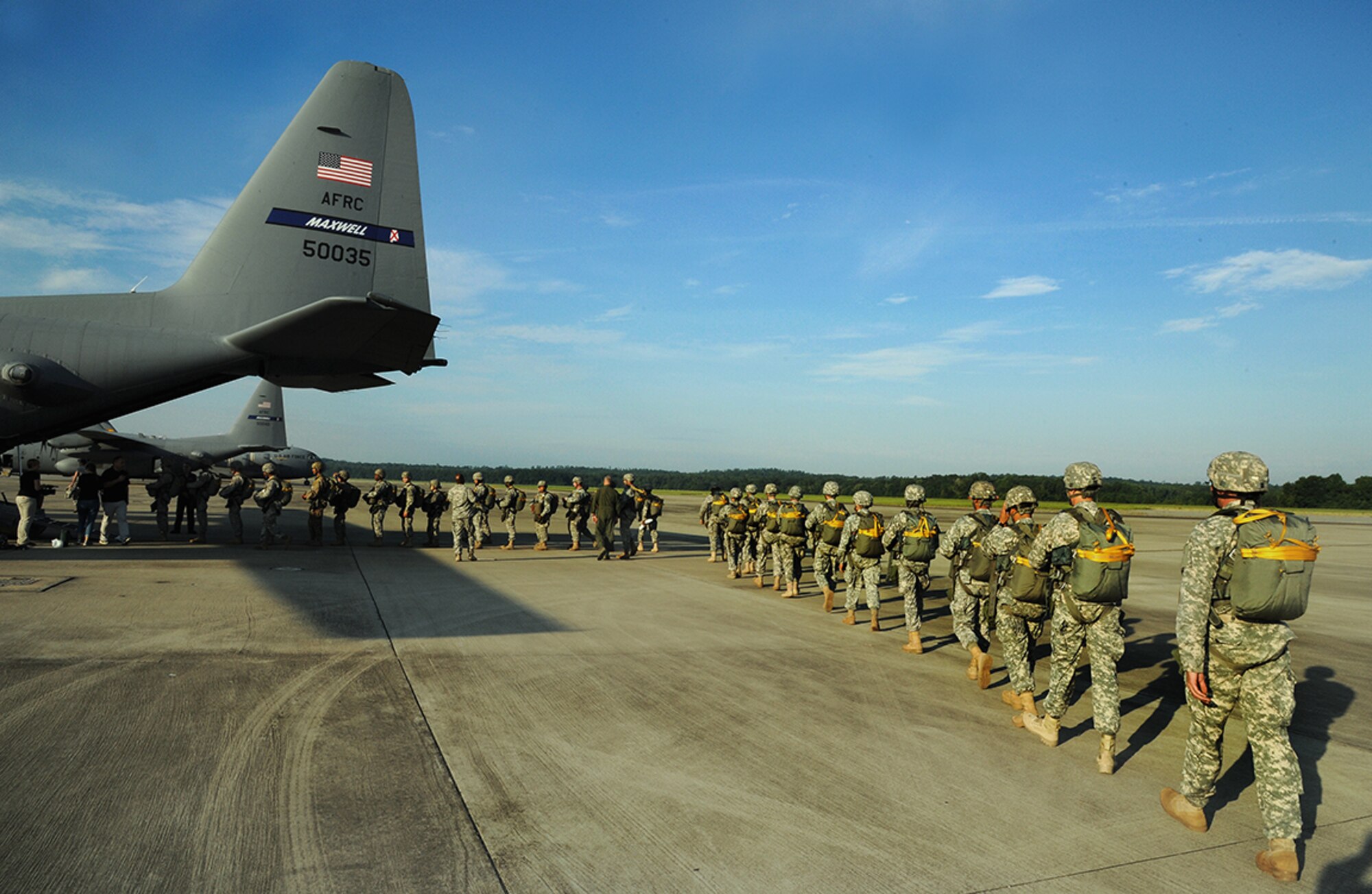 Army and Marine paratroopers taking part in the airborne anniversary jump board the 908th C-130. (photo by Lt. Col. Jerry Lobb)