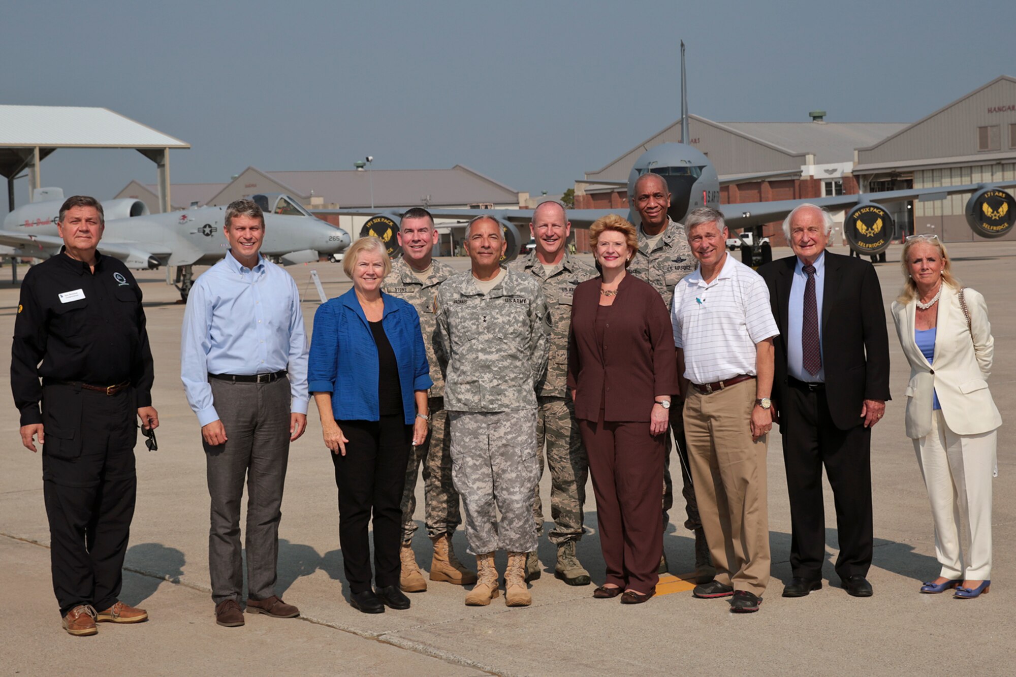 U.S. Rep. Dan Benishek, R-Mich., U.S. Rep. Bill Huizenga, R-Mich., U.S. Rep. Candice Miller, R-Mich., Major Gen. Gregory J. Vadnais, U.S. Sen. Debbie Stabenow, D-Mich., U.S. Rep. Fred Upton, R-Mich., U.S. Rep. Sander Levin, D-Mich., and U.S. Rep. Debbie Dingell, D-Mich., stand in front of an A-10 Thunderbolt II and KC-135 Stratotanker aircraft at Selfridge Air National Guard Base, Mich., Sept. 2, 2015. Vadnais is the adjutant general of the Michigan National Guard. Standing in the back row are Brig. Gen. Michael A. Stone, assistant adjutant general of Michigan for installations; Brig. Gen. John D. Slocum, 127th Wing commander; and Brig. Gen. Leonard W. Isabelle, commander of the Michigan Air National Guard. Both aircraft are operated by the 127th Wing at Selfridge. The Congressional members toured the base to learn about the capabilities and missions of the 40-plus units assigned to Selfridge. (U.S. Air National Guard photo by Terry Atwell / Released)