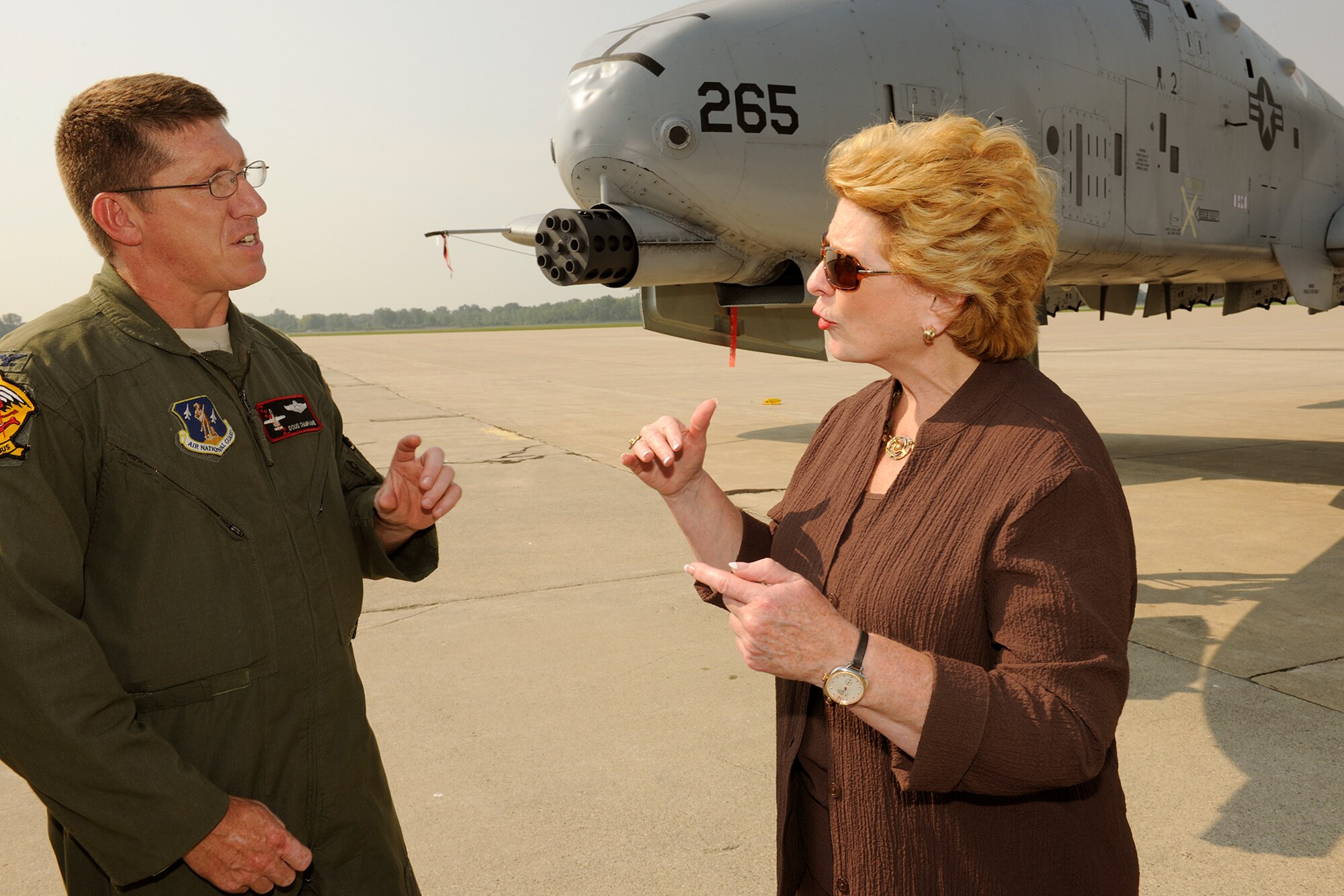 150902-Z-EZ686-087 -- Col. Douglas Champagne, commander of the 127th Operations Group and an A-10 Thunderbolt II pilot, explains the capabilities of the aircraft to U.S. Sen. Debbie Stabenow, D-Mich., during a visit by a Congressional delegation to Selfridge Air National Guard Base, Mich., Sept. 2, 2015. Selfridge was the first stop on a two-day tour of all of Michigan major military installations. Seven Michigan members of Congress and many of their staff aides participated in the trip. (U.S. Air National Guard photos by Master Sgt. David Kujawa / Released)