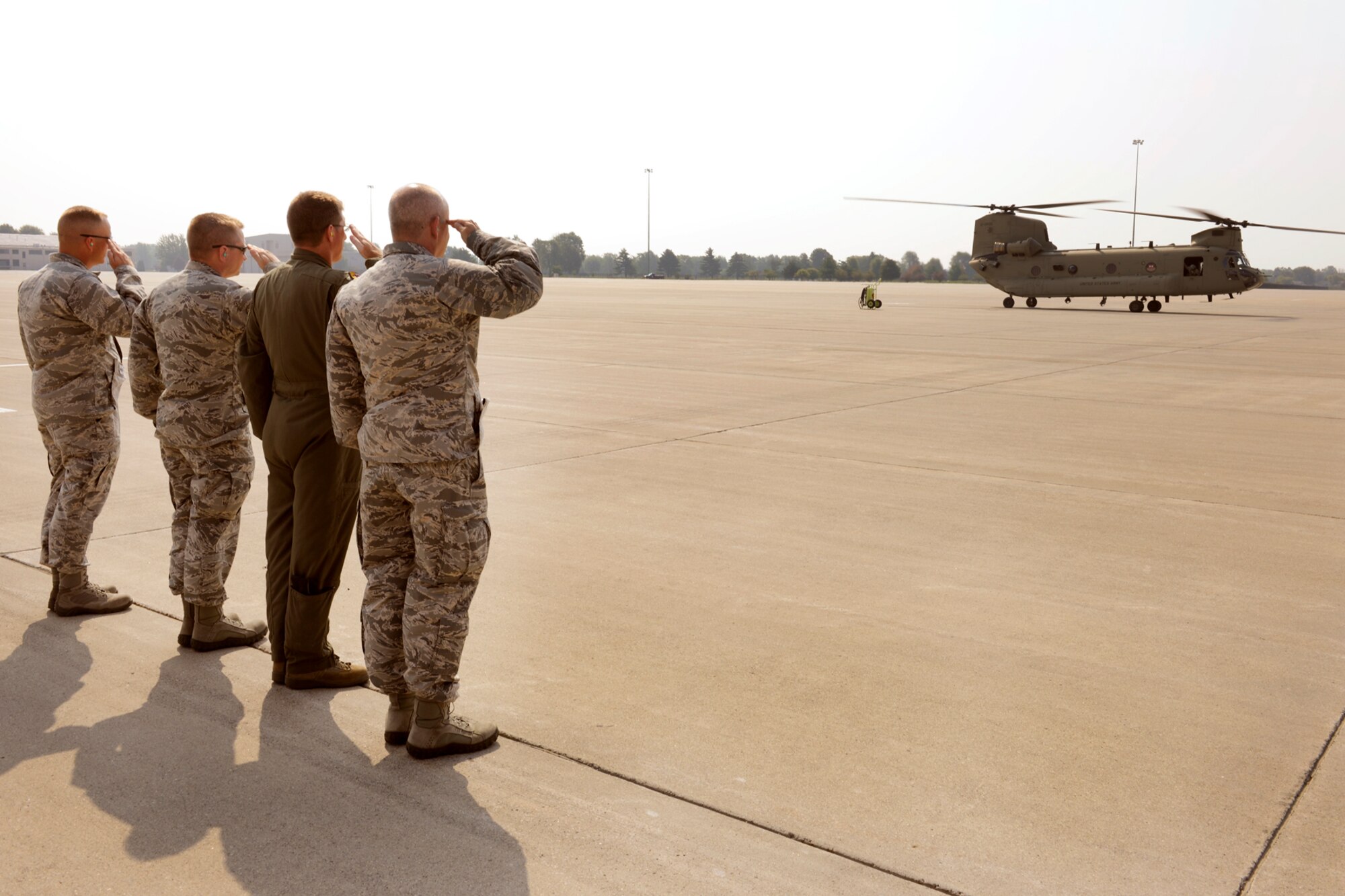 150902-Z-EZ686-249 -- From the right, Brig. Gen. John D. Slocum, 127th Wing commander; Col. Douglas Champagne, 127th Operations Group commander; Col. Rolf Mammen, 127th Wing vice commander and Major Kurt Ring, 127th Aircraft Maintenance Squadron commander, salute two CH-47 Chinook helicopters transporting seven members of Congress who toured Selfridge Air National Guard Base on Sep. 2, 2015.  In an historic visit, seven members of Congress toured Selfridge ANGB to gain insight into the diverse missions, capabilities and the future potential of the base.  (Air National Guard photo by Master Sgt. David Kujawa/Released)