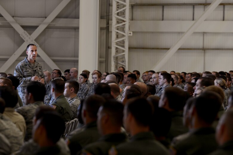 Col. Leonard Kosinski (standing left), 62nd Airlift Wing commander, speaks during his first 62nd AW commander’s call Sept. 1, 2015 at Joint Base-Lewis McChord, Wash. Kosinski ‘s main talking points focused on the “six T’s” of: teamwork, trust, talent, treasure, time management and treat. (U.S Air Force photo/ Staff Sgt. Tim Chacon)