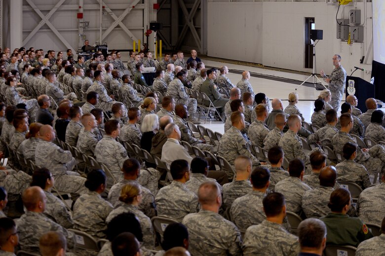 Col. Leonard Kosinski (standing right) 62nd Airlift Wing commander, talks to Airmen from the 62nd AW during his commander’s call Sept. 1, 2015 at Joint Base Lewis-McChord, Wash. This was Kosinski’s first 62nd AW commander’s call after taking command of the 62nd AW, June 29, 2015. (U.S Air Force photo/ Staff Sgt. Tim Chacon)