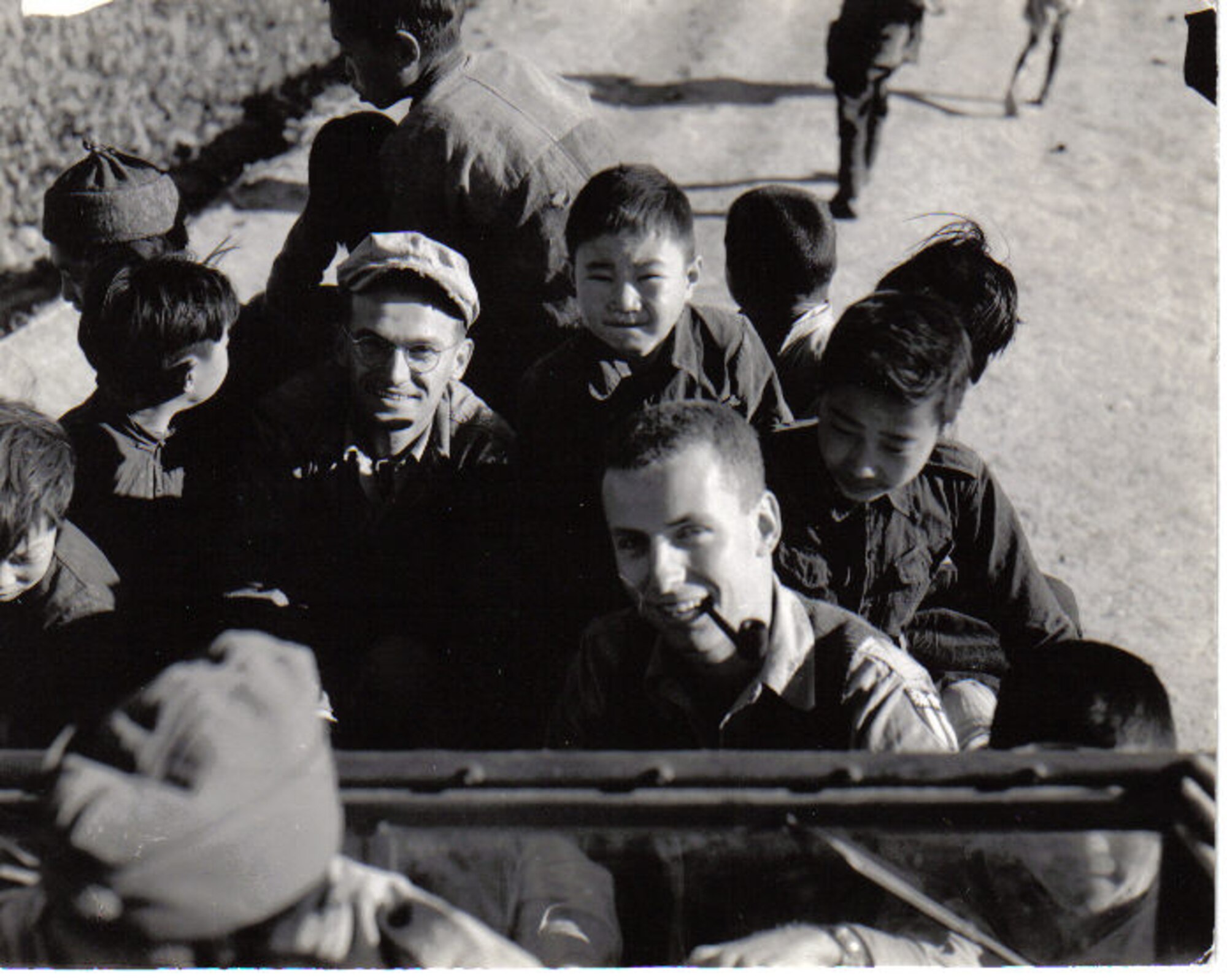 S/Sgt John Brasko (left, a Pennsylvania Air Guardsman before and after the war) and 1st Lt. Arthur Clark (who remained on active duty and became a Major General) smile for the camera as Clark drives a jeep with accompanying as young Chinese citizens at Chengkung Airfield in China, circa early 1945.  They served with “G” Flight of the 35th Photo Recon Squadron at several different forward airfields.  (Courtesy Mr. John Brasko, Jr.)