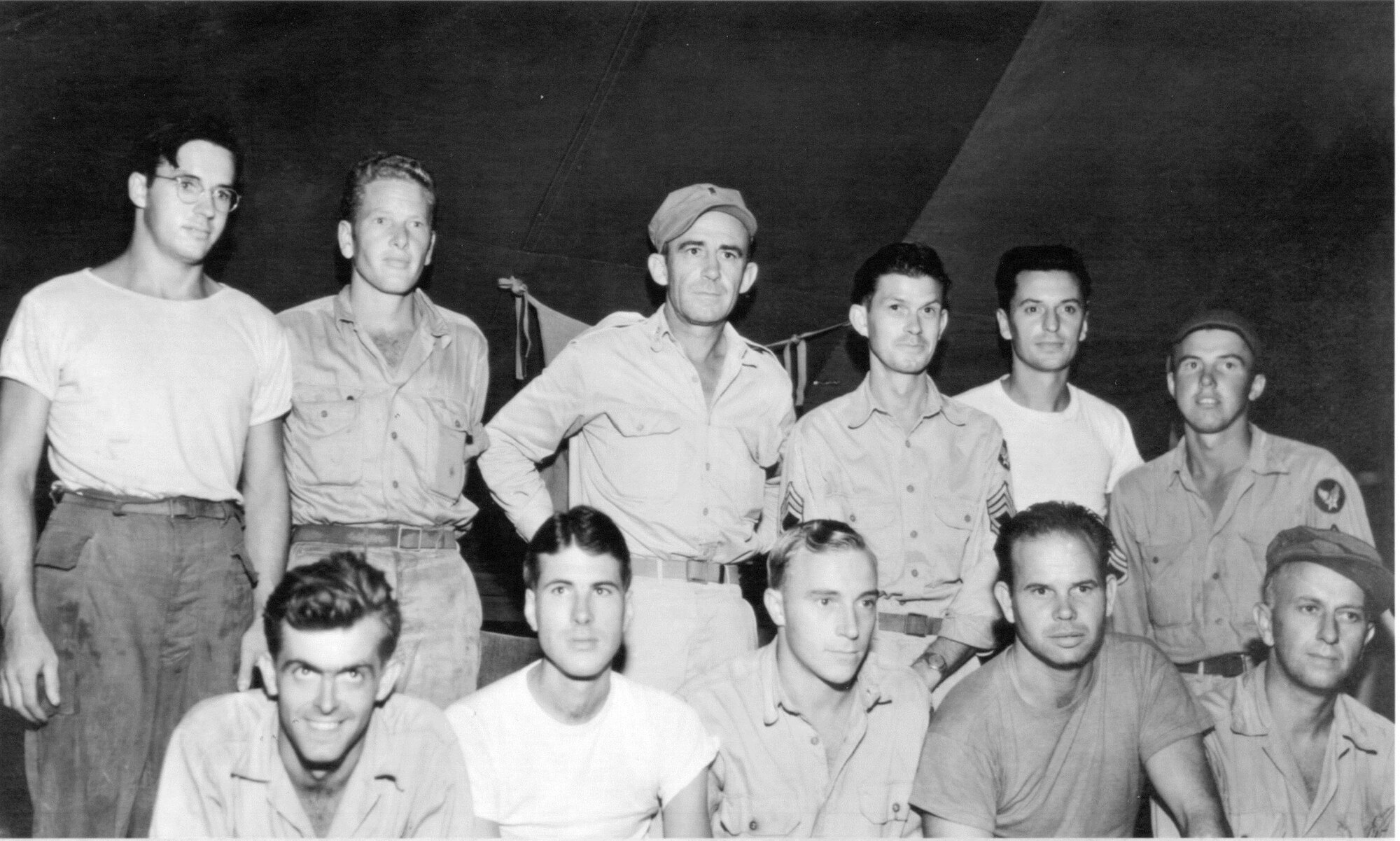 Eleven of Oregon's original Air Guardsmen had a relatively pleasant wartime reunion on the island of Biak, off the northwest coast of New Guinea in the Netherlands East Indies in late September or October of 1944. It was the first gathering between them since leaving Oregon's 123rd Observation Squadron for other air force assignments earlier in the war, as the Army Air Forces reassigned many 123d members to help build up other new air units. Representing five different outfits of the Fifth Air Force, they are (back row, from left), Sgt. Fred H. Hill (17th Reconnaissance Squadron (17RS)), Sgt.Onan S. Beasley, 1st Lt. John P. O'Keefe (a Military Police unit), M/Sgt. Joe H. Weber, S/Sgt. Anthony J. Flabetich, S/Sgt. John L. Donis (110th Tactical Reconnaissance Squadron); (seated, from left) Sgt. Robert W. Casey (17RS), S/Sgt. Robert F. Wall (17RS), S/Sgt. John H. Sopjes (17RS), T/Sgt. Walter M. Barker (17RS) and Pvt. Jack L. Barton. The units the other men belonged to are unknown; there were several units based on Biak in this period, including the 71st Tactical Reconnaissance Group, 345th Bomb Group (Medium) and the 475th Fighter Group.  (142FW Archives)