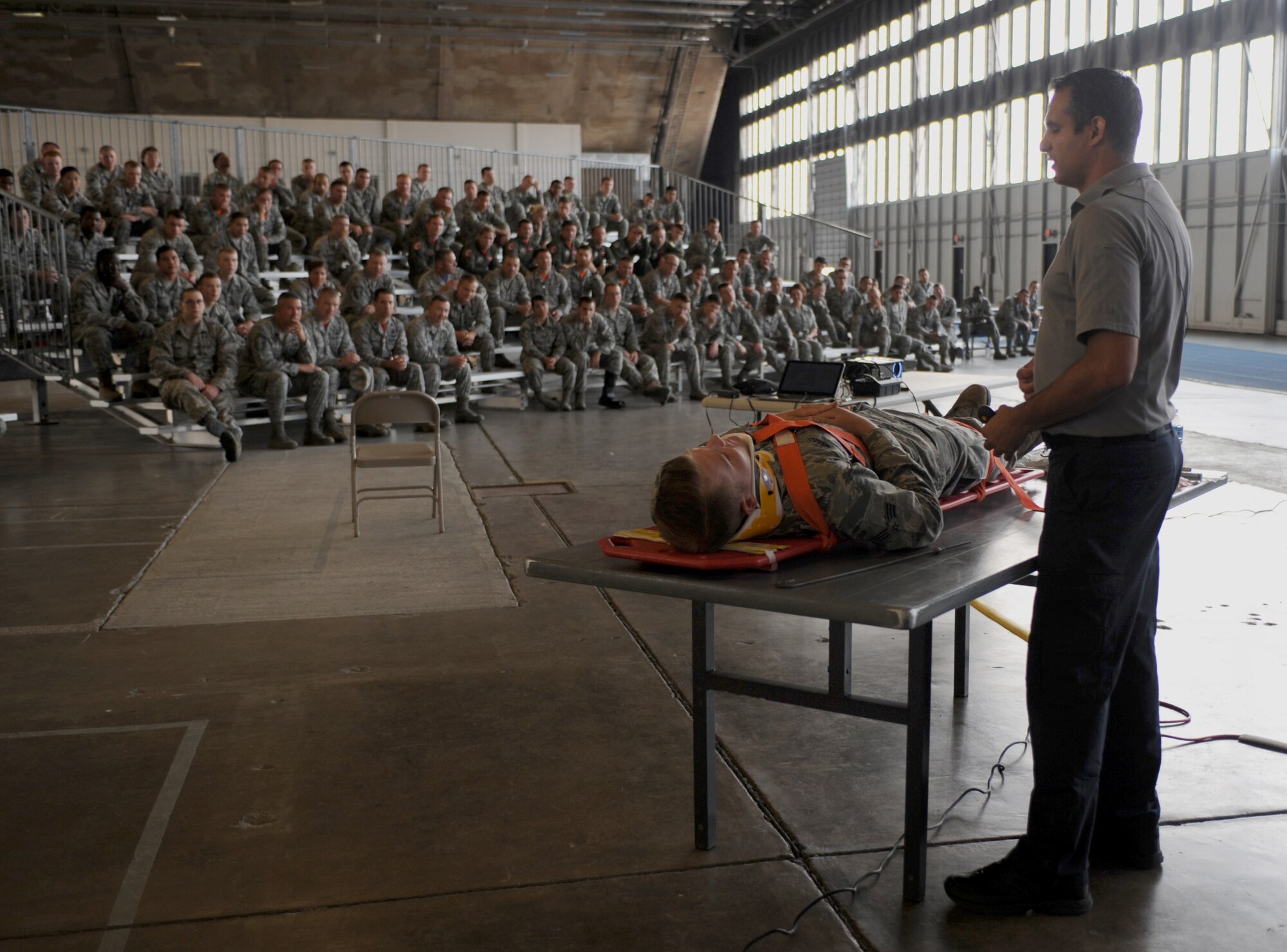 Oscar Duran, Miami-Dade Fire Rescue paramedic, speaks to Airmen about emergency medical procedures during a Street Smart presentation at Ellsworth Air Force Base, S.D., Aug. 28, 2015. During the event, Duran explained that victims of major vehicle crashes can endure possible life-saving treatments, such as an IV drip, chest decompression and a breathing apparatus. (U.S. Air Force photo by Airman 1st Class Denise M. Nevins/Released)