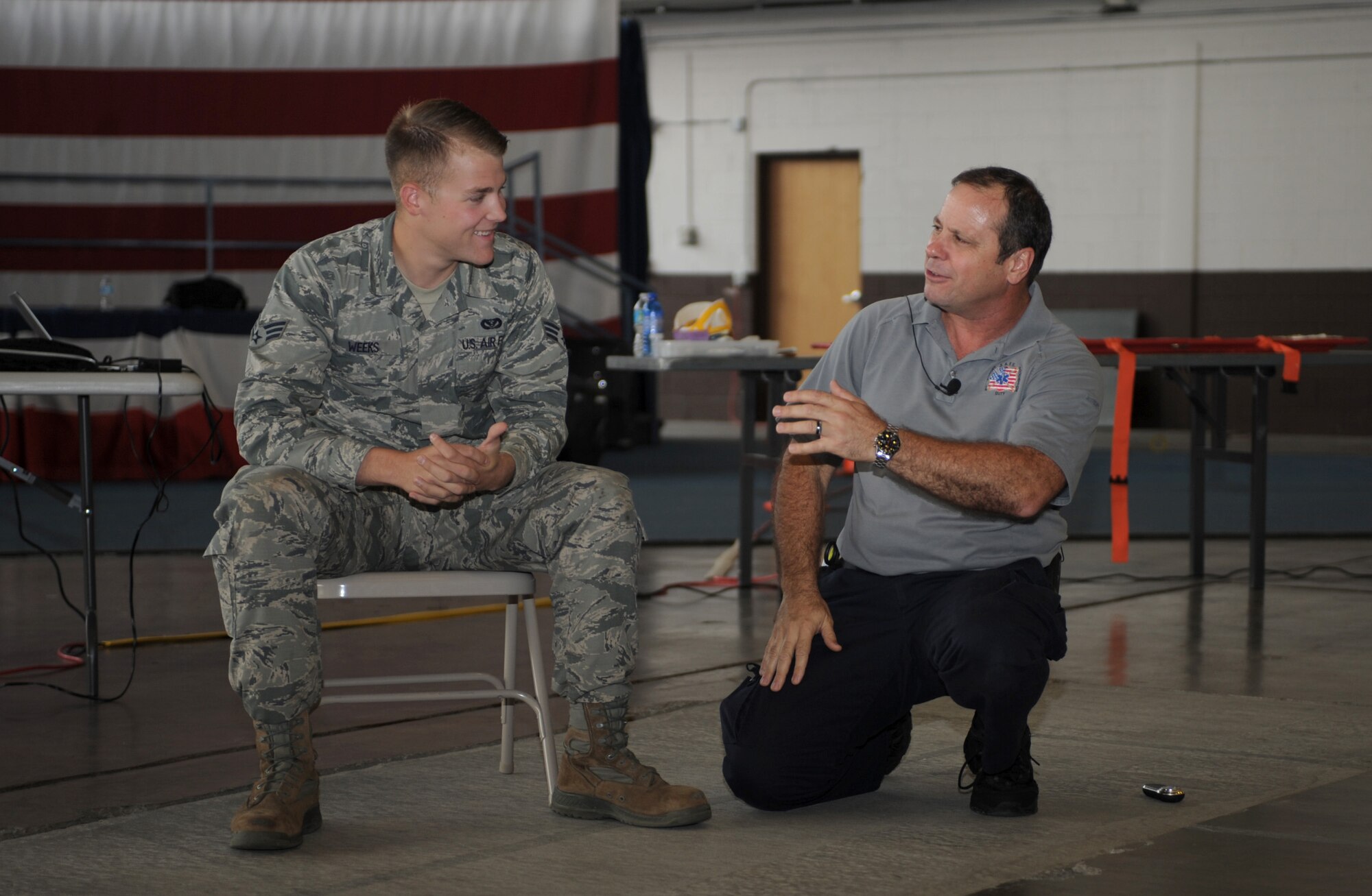 Senior Airman Bradley Weeks, 28th Civil Engineer Squadron Heating, Ventilation, Air Conditioning and Refrigeration technician, and Ralph Jimenez, Street Smart program volunteer, participate in a scenario discussion during a Street Smart presentation at Ellsworth Air Force Base, S.D., Aug. 28, 2015. The purpose of the Street Smart program is to educate audience members of the consequences of distracted and drunk driving using graphic imagery and videos of real victims. (U.S. Air Force photo by Airman 1st Class Denise M. Nevins/Released)