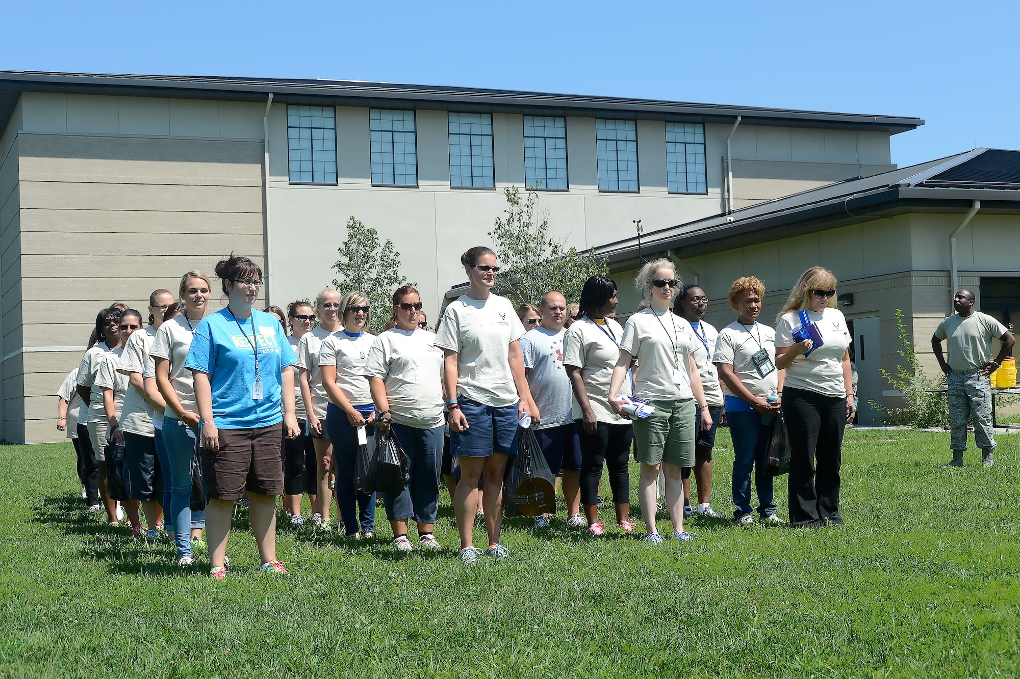 Teachers get into formation prior to marching to begin their deployment as part of Operation Kids/Teachers Understanding Deployment Operations (KUDOS/TUDOS)  Aug. 26, 2015, at the Youth Center on Dover Air Force Base, Del.  Military personnel guided the teachers through their deployment stations to keep them focused and on track. (U.S. Air Force photo/Greg L. Davis)