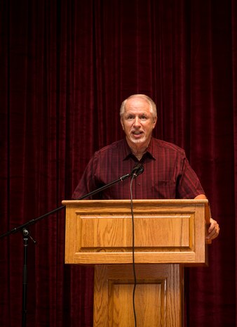 Mr. John Hood, U.S. Air Force Expeditionary Center honorary commander talks to Airmen and Sailors during an all call Sep. 1, 2015, at the base movie theater on Joint Base Charleston, S.C. The U.S. Air Force Expeditionary Center is the Air Force's Center of Excellence for advanced expeditionary combat support training and education, while also providing direct oversight for en route and installation support, contingency response, and partner capacity building mission sets within the global mobility enterprise. The Expeditionary Center provides operational control of the Expeditionary Operations School and administrative control for six wings and two groups within Air Mobility Command. (U.S. Air Force photo/Airman 1st Class Clayton Cupit)