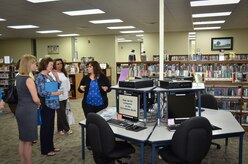 (Right) Angela Aschenbrenner, Joint Base Charleston Libraries director, gives a tour to Barbara Martin, wife of Maj. Gen. Frederick Martin, commander of the U.S. Air Force Expeditionary Center, during a base visit, Sept. 2, 2015 at Joint Base Charleston – Weapons Station, S.C. The purpose of the visit was to provide an overview of the library services available on the joint base. (U.S. Air Force photo/Staff Sgt. AJ Hyatt)