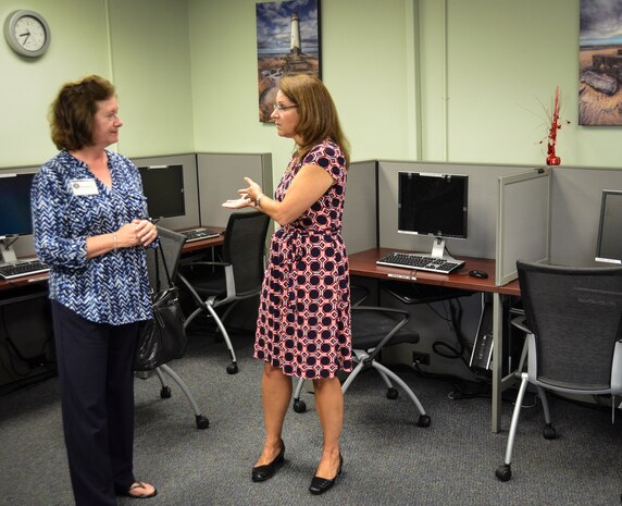 (Right) Elsa Summers, Airmen and Family Readiness Center director, provides a tour of the Fleet and Family Support Center to Barbara Martin, wife of Maj. Gen. Frederick Martin, commander of the U.S. Air Force Expeditionary Center, during a base visit, Sept. 2, 2015 at Joint Base Charleston – Weapons Station, S.C. The purpose of the visit was to showcase the unique Navy programs in the Fleet and Family Support Center and to show how they meet the specific needs of the sailors in the nuclear power training units. (U.S. Air Force photo/Staff Sgt. AJ Hyatt)