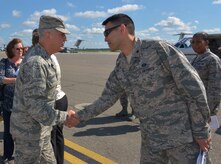 (From left to right) Maj. Gen. Frederick Martin, U.S. Air Force Expeditionary Center commander, Joint Base McGuire-Dix-Lakehurst, NJ, greets with Maj. Woo Suk Chun, 628th Civil Engineer Squadron operations flight commander, Joint Base Charleston, SC, on the flight line at JB Charleston, SC, Sept. 1, 2015. Martin was accompanied by his wife, Barbara, Brig. Gen. James Scanlan, Mobilization Assistant to the commander of the U.S. Air Force Expeditionary Center, John Hood, honorary commander of the U.S. Air Force Expeditionary Center and Chief Master Sgt. Peter Stone, U.S. Air Force. EC command chief. During his visit, Martin toured various locations across the Air Base and Weapons Station where he was able to interact with several of Joint Base Charleston’s Mission Partners. The U.S. Air Force Expeditionary Center is the Air Force's Center of Excellence for advanced expeditionary combat support training and education, while also providing direct oversight for en route and installation support, contingency response and partner capacity building mission sets within the global mobility enterprise. (U.S. Air Force photo/Airman 1st Class Thomas T. Charlton)