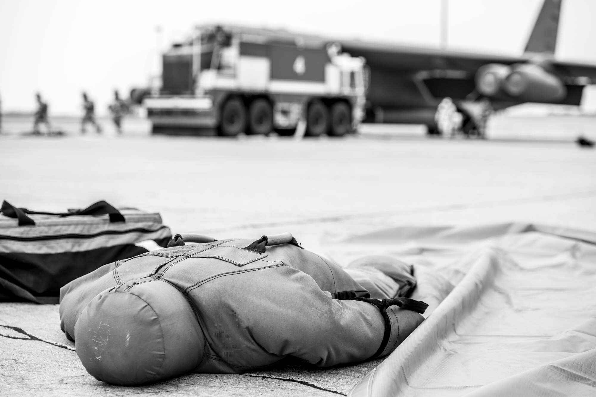 A training dummy, representing a victim, lies on the flightline after being rescued from a simulated B-52H Stratofortress engine fire during a training exercise at Minot Air Force Base, N.D., August 28, 2015. The two training dummies represented injured personnel, one in the cockpit and the other outside the aircraft, were used to test firefighters ability to evacuate victims from difficult locations. (U.S. Air Force photo/ Airman 1st Class Justin T. Armstrong)

