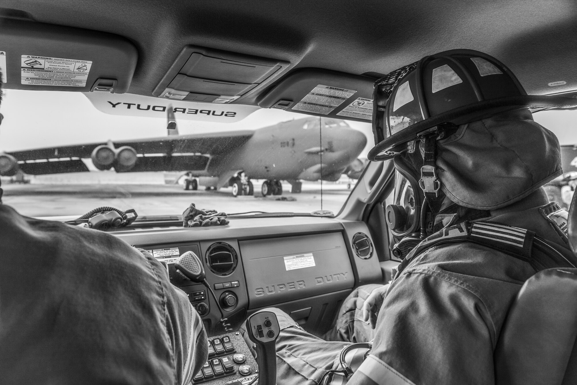 Terence Sinner, 5th Civil Engineer Squadron HAZ MAT technician, rides to the site of a simulated B-52H Stratofortress fire during an exercise on the flightline at Minot Air Force Base, N.D., August 28, 2015. The purpose of the exercise was to grade the firefighters ability to work as a team to shutdown the aircraft, extinguish a simulated engine fire and evacuate and treat two victims. (U.S. Air Force photo/ Airman 1st Class Justin T. Armstrong)