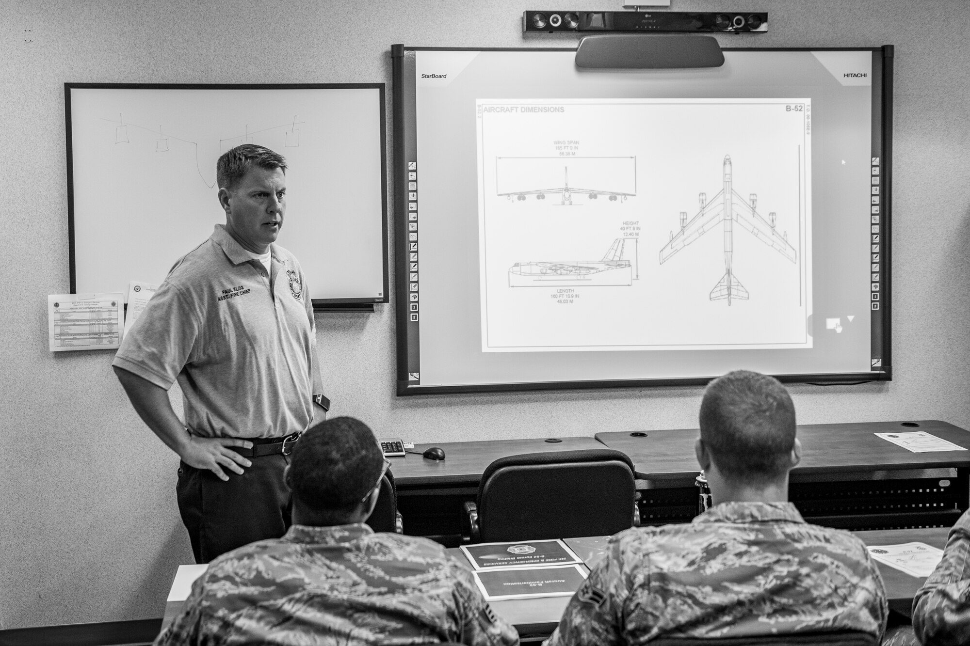 Paul Klug, 5th Civil Engineer Squadron assistant fire chief, reminds firefighters about safety involved with the B-52H Stratofortress before a training exercise at Minot Air Force Base, N.D., August 28, 2015. The purpose of the exercise was to grade the firefighters ability to work as a team to shutdown the aircraft, extinguish a simulated engine fire and evacuate and treat two victims. (U.S. Air Force photo/ Airman 1st Class Justin T. Armstrong)
