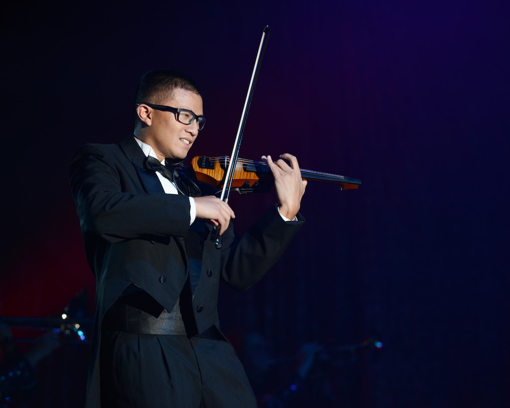 U.S. Air Force 1st Lt. Oliver Chang, Space and Missiles System Center developmental engineer, plays the violin during the 2015 Tops in Blue World Tour Aug. 28, 2015, at the Abilene Civic Center in Abilene, Texas. Tops in Blue was established in 1953 to recognize the high caliber of amateur entertainment available within the Air Force. (U.S. Air Force photo by Senior Airman Kedesha Pennant/Released)