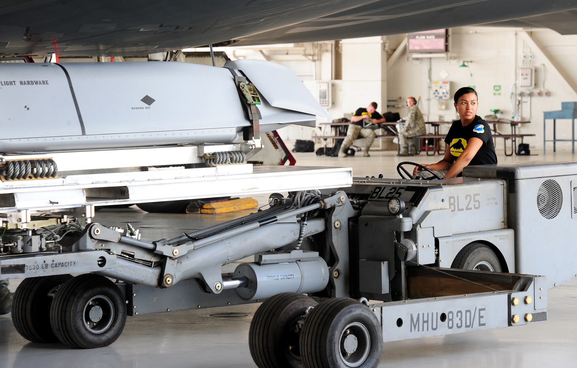 Airman 1st Class Tatayana Garvin, 509th Aircraft Maintenance Squadron aircraft armament system technician, transports munitions to the weapons bay of the B-2 Spirit Aug. 11, 2015, at Whiteman Air Force Base, Mo. The Global Strike Challenge involves several bomb and missile wings from Air Force Global Strike Command competing to represent their base at the individual, team and unit level. (U.S. Air Force photo by Airman 1st Class Jazmin Smith/Released)