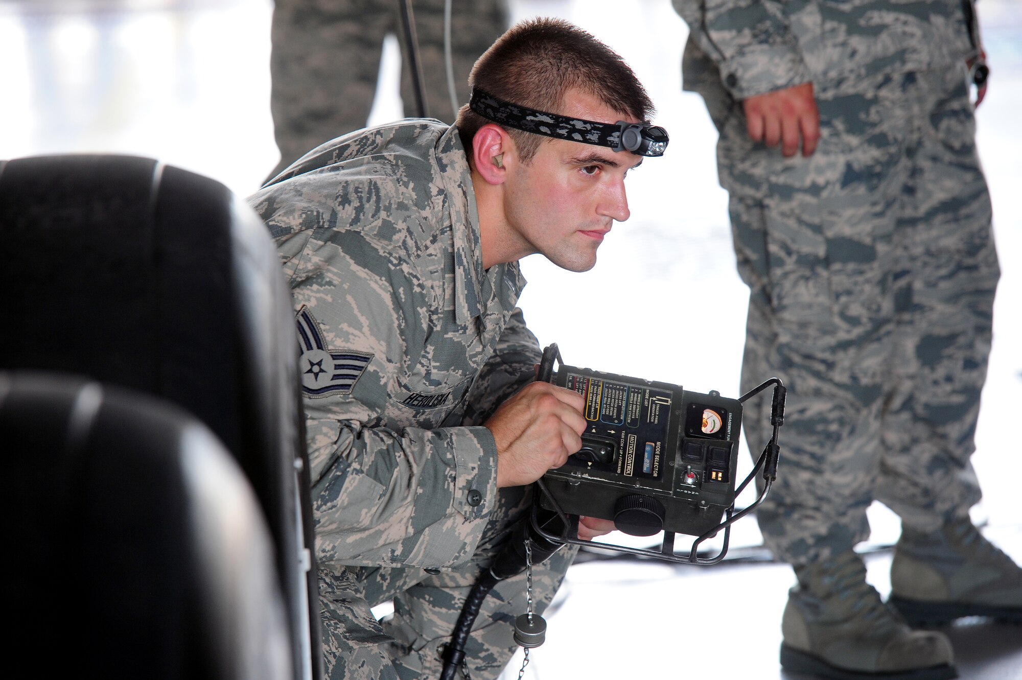 U.S. Air Force Staff Sgt. Joseph Herdliska, 131st Aircraft Maintenance Squadron aircraft armament system technician, performs a jack stow operation on the munitions handling unit (MHU)-204 trailer Aug. 12, 2015, at Whiteman Air Force Base, Mo. Herdliska used the power control unit to perform all movements of the MHU-204 trailer, including removing it from under the aircraft after the rotary launcher assembly was loaded. (U.S. Air Force photo by Airman 1st Class Jazmin Smith/Released) 