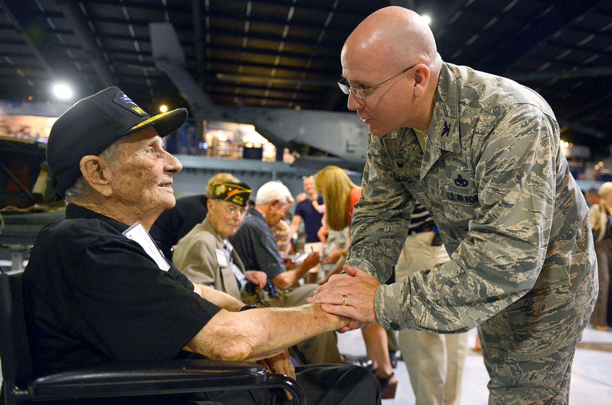 Col. Jeffrey King, Robins’ installation and 78th Air Base Wing commander, greets John Barrett, Army veteran, during a reception at the Museum of Aviation in Warner Robins, Ga., Aug. 21. Barrett – a private first class during the war -- received a Purple Heart and Silver Star after being wounded in action and taken as a prisoner of war during World War II. The reception honored veterans who served aboard B-17s and celebrated the arrival of a B-17 Flying Fortress which will be displayed at the museum. The engines, wings and tail section of the aircraft -- which arrived a day earlier -- were on display during the reception. At the event, several B-17 crew members shared their memories of the aircraft with nearly 200 attendees. (U.S. Air Force photo by Tommie Horton)