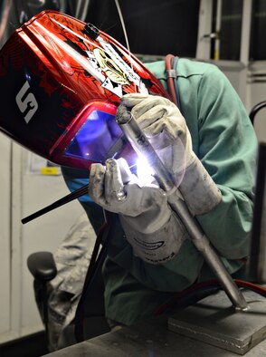 Tech. Sgt. Alicia Raschke, with the Air Force Reserves at March Air Reserve Base, Calif., practices a 6G weld as part of the required training for welding certification. The Tinker welding shop certifies all levels of Air Force and Reserve welders, in addition to keeping qualifications up-to-date. Welders have to re-certify every three years. (Air Force photo by Kelly White/Released)