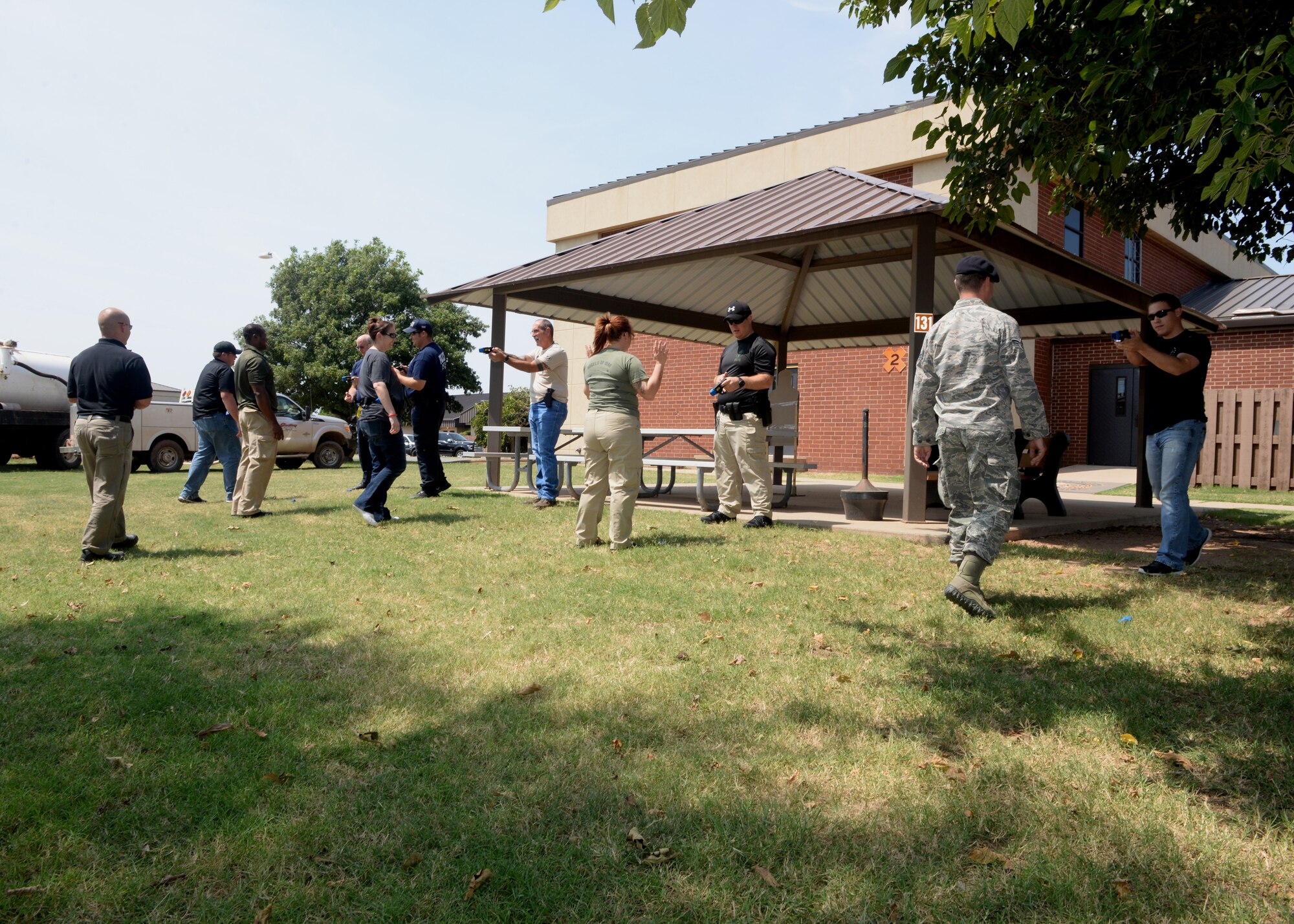 ALTUS AIR FORCE BASE, Okla. – Members of the Altus Police Department and 97th Security Forces Squadron practice quick-reaction draw and firing using a Taser X26 non-lethal weapon during a joint training course Aug. 26, 2015. Due to the nature of their work, and to save money, the Altus Police Department and the 97th frequently share their training capabilities with each other. (U.S. Air Force photo by Airman 1st Class Megan Acs/Released)