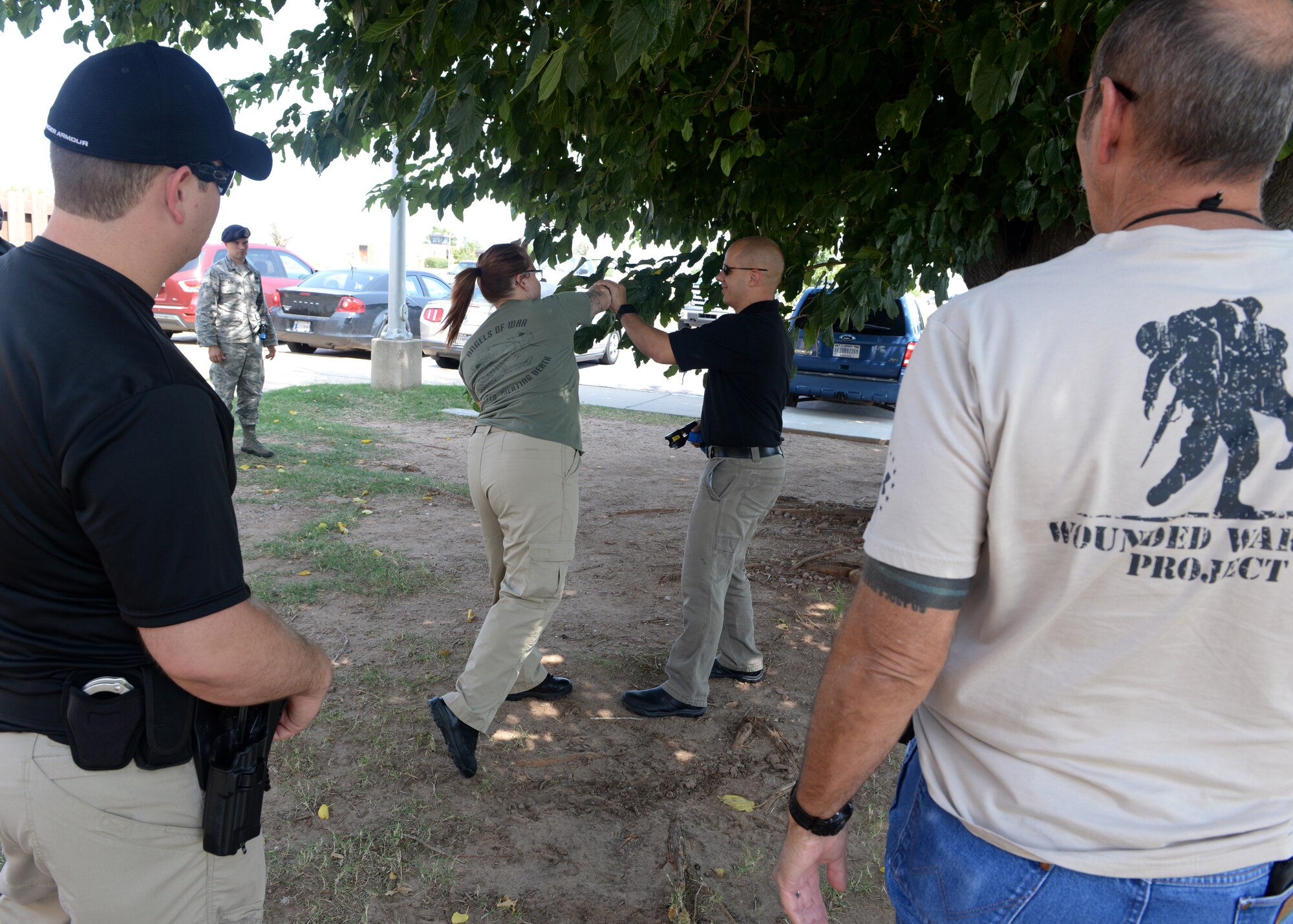 ALTUS AIR FORCE BASE, Okla. – Members from the Altus Police Department and 97th Security Forces Squadron view a demonstration of how to perform a quick-reaction draw and fire using a Taser X26 non-lethal weapon during a joint training course Aug. 26, 2015. U.S. Air Force Tech. Sgt. Joshua Leach, a certified Taser Master Instructor, provided this training to 23 Altus Police Department officers for free, saving the City of Altus approximately $9,200 in training costs. (U.S. Air Force photo by Airman 1st Class Megan Acs/Released)