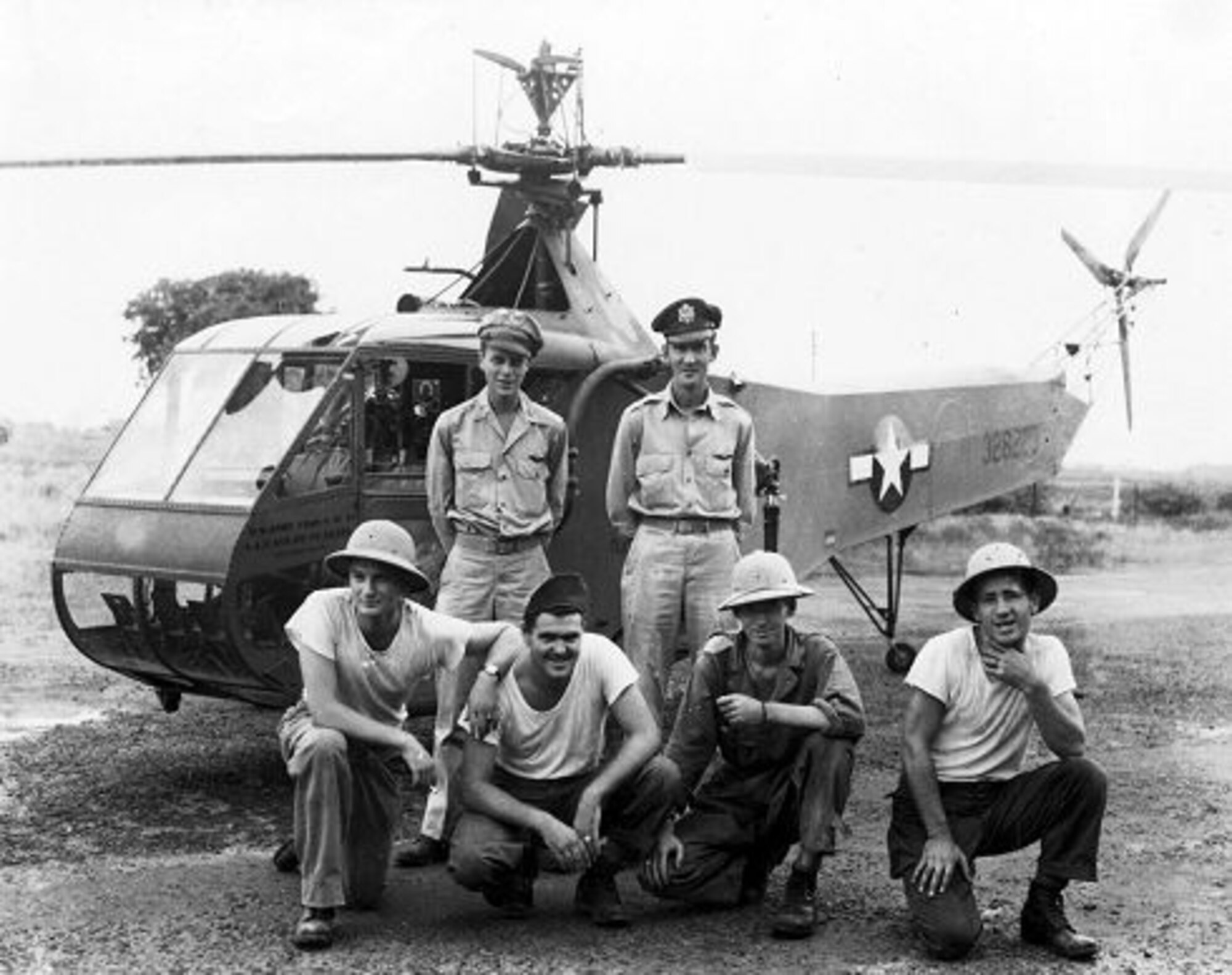 U.S. Air Force Museum photo, probably taken in January 1945, shows Lt. Carter Harman (standing left), with ground crew, including his crew-chief/mechanic, Sgt. Jim Phelan (front row right). Lt. Frank Peterson, a veteran R-4 test pilot who performed a later epic Burma rescue mission with a YR-4B, stands beside Lt. Harman.