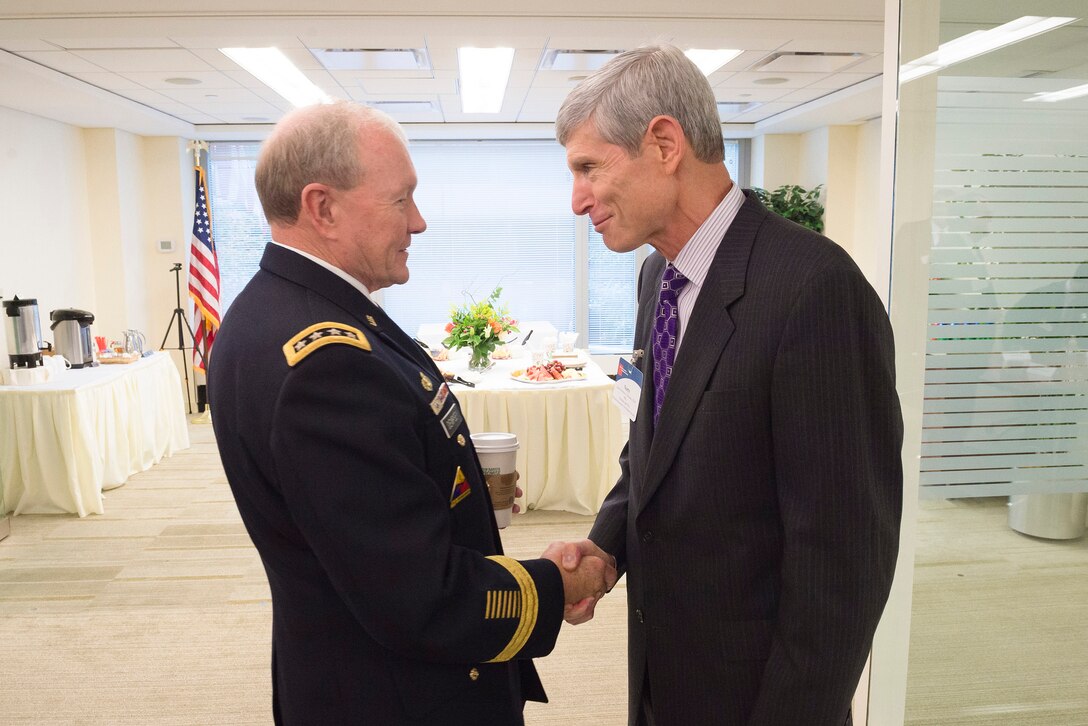 Army Gen. Martin E. Dempsey, chairman of the Joint Chiefs of Staff,  exchanges greetings with retired Air Force Gen. Norton A. Schwartz at the Business Executives for National Security headquarters in Washington, D.C., Sept. 2, 2015. Schwartz, a former Air Force chief of  staff, is the organization's president and CEO. DoD photo by U.S. Army Staff Sgt. Sean K. Harp