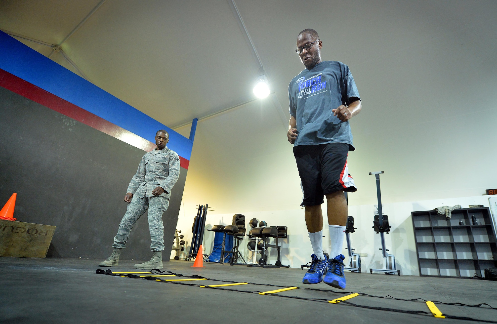 Senior Airman Akil, 380th Expeditionary Medical Group noncommissioned officer in charge physical therapy clinic, left, directs Staff Sgt. Jamey, 380th Expeditionary Security Forces Squadron member, through strength and agility exercises at undisclosed location in Southwest Asia Sept. 3, 2015. The physical therapy team utilizes the strength and agility program to help restore physical abilities. (U.S. Air Force photo/Tech. Sgt. Jeff Andrejcik)  