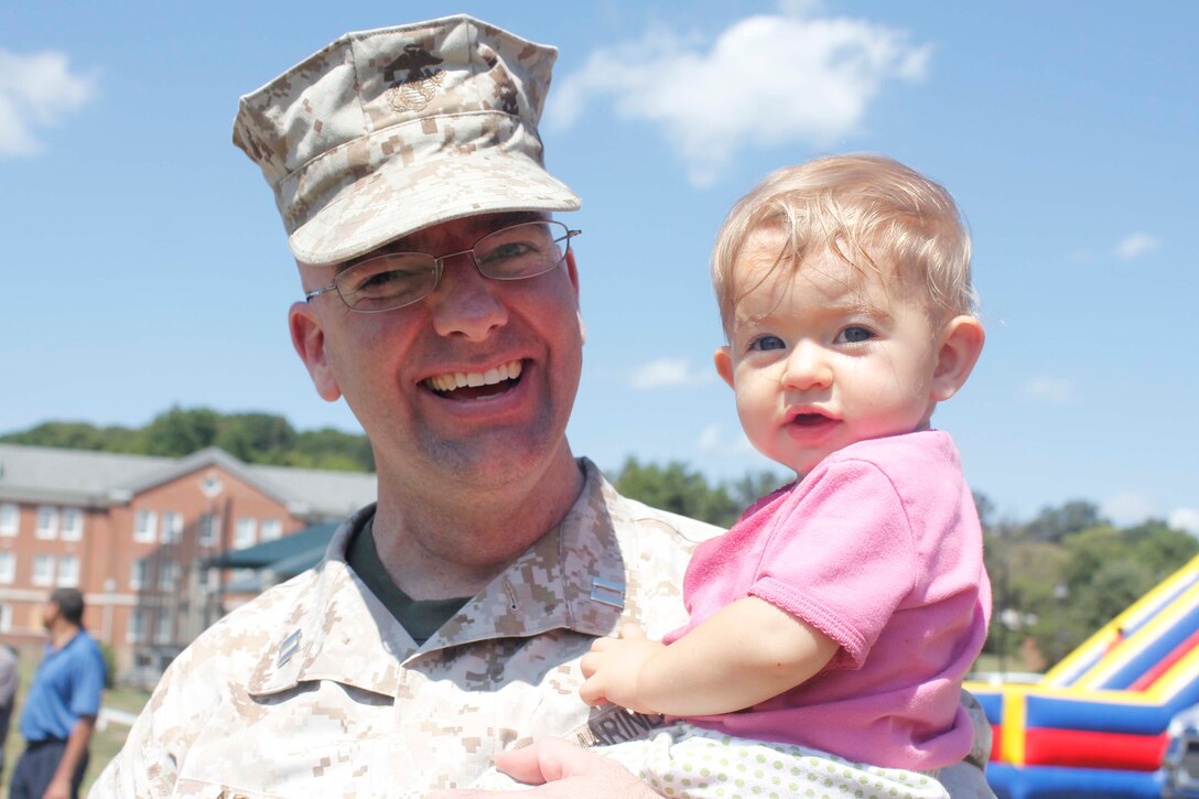 Capt. Nathan Adams and his youngest daughter attend the Training and Education Command Family Day Picnic at Barnett Field, Aug. 27. Adams works in TECOM as the deputy staff judge advocate.