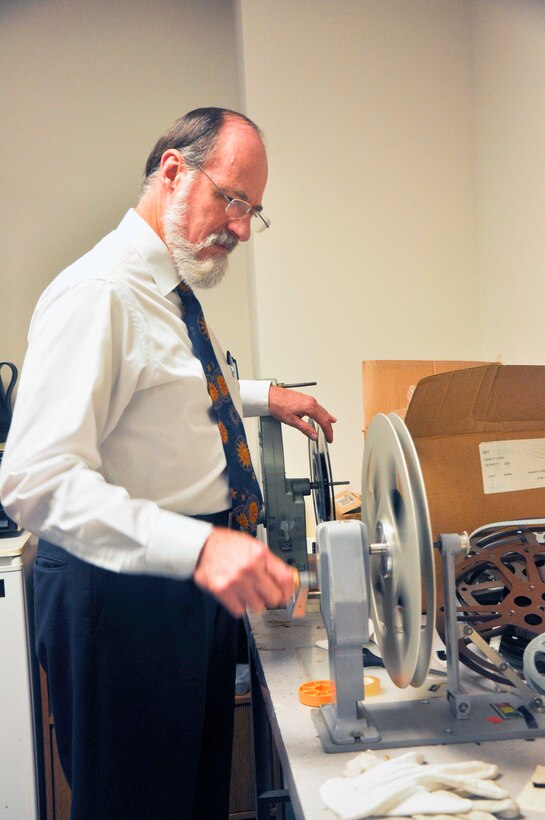 Tom Baughn, Marine Corps History Division historian, properly stores a film reel showing Marines, which will be used for a compilation to celebrate the 100th Anniversary of the U.S. Marine Corps Reserves. Baughn converts film into digital files, which can be viewed in DVD format. Hundreds of 16mm films are digitized here and added to the vast collection of works, which is available to the public.