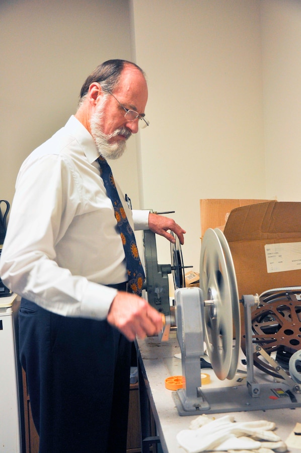 Tom Baughn, Marine Corps History Division historian, properly stores a film reel showing Marines, which will be used for a compilation to celebrate the 100th Anniversary of the U.S. Marine Corps Reserves. Baughn converts film into digital files, which can be viewed in DVD format. Hundreds of 16mm films are digitized here and added to the vast collection of works, which is available to the public.