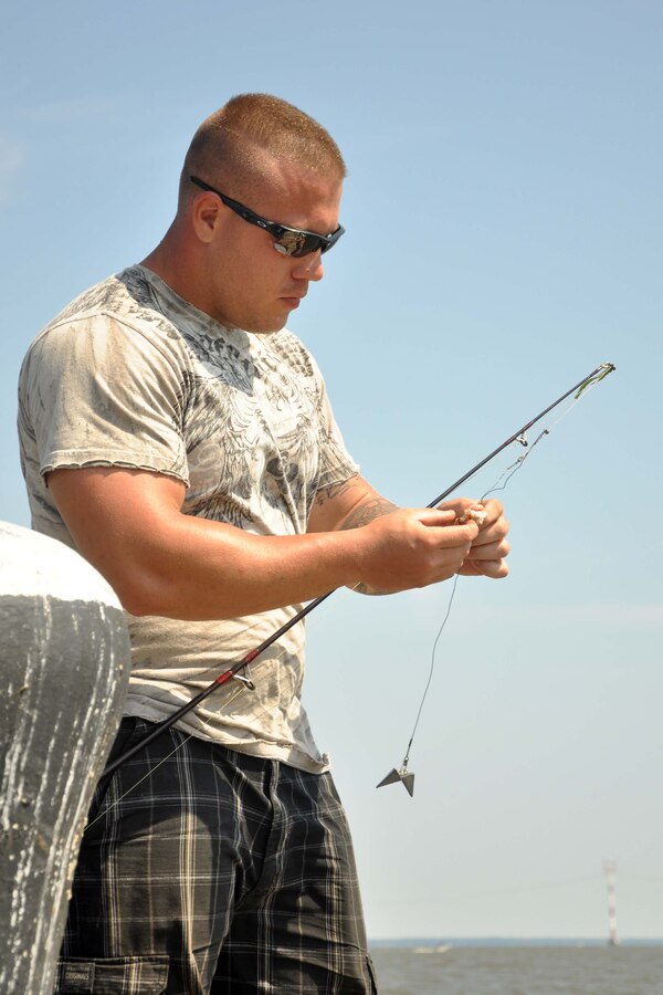 Cpl. Joshua Horne, an infantryman stationed aboard Marine Corps Base Quantico, baits a fishing line during the final five hours of the Quantico Classic Fishing Tournament on Aug. 29. The 30-hour tournament began Aug. 28 at noon on the Potomac River in The Town of Quantico. The tournament is in its second year.