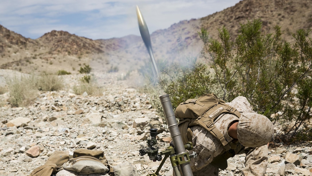 Pfc. Anthony C. Alamillo and Pfc. Nathan S. Barnes, mortarmen with Weapons Company, 2nd Battalion, 7th Marine Regiment, provide support fire with a M224A1 60mm Mortar System during Exercise Chosin, a squad-level training evolution, at Range 410, Marine Corps Air Ground Combat Center Twentynine Palms, California, Aug. 26, 2015. The Marines with Weapons Company provided support to E Company as they executed an assault course. 