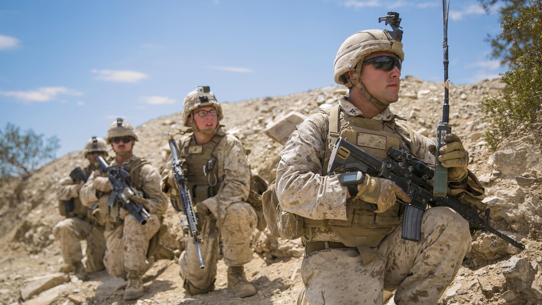 Lance Cpl. John R. Camp, squad leader, with E Company, 2nd Battalion, 7th Marine Regiment, leads his squad through an assault course during Exercise Chosin, a squad-level training evolution, at Range 410, Marine Corps Air Ground Combat Center Twentynine Palms, California, Aug. 26, 2015. The exercise assessed and evaluated all squads in offensive, defensive and urban terrain operations.  