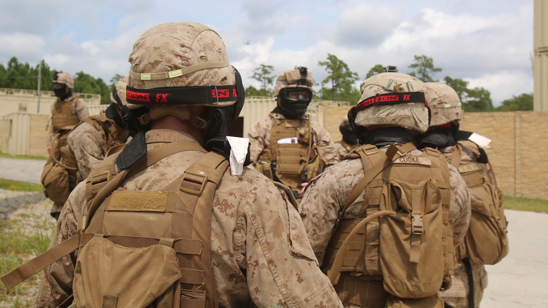 A squad with Fox Company, 2nd Battalion, 2nd Marine Regiment, consolidate and debrief after a round of military operations in urban terrain training aboard Camp Lejeune, N.C., Aug. 26, 2015. Debreifing the Marines lets them know what they did right, and what they could improve on. 