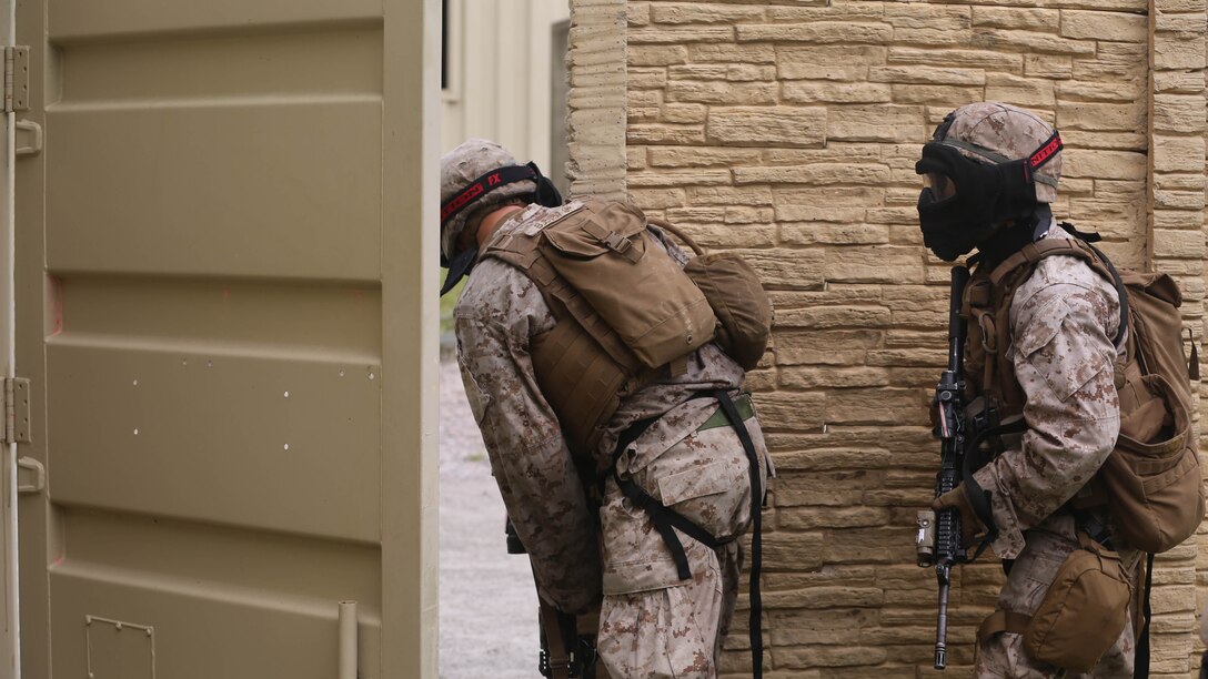 The front man of a fire team with Fox Company, 2nd Battalion, 2nd Marine Regiment, checks the way to move from building to building as part of military operations in urban terrain training conducted aboard Camp Lejeune, N.C. Aug. 26, 2015. “We’re looking for team leaders that can make initiative based decisions.” said 2nd Lt. Kevin Thomas, a platoon commander with Fox Co.
