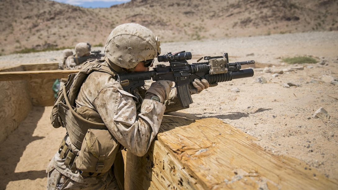 Lance Cpl. Gabriel J. Weaver, rifleman with E Company, 2nd Battalion, 7th Marine Regiment, provides cover fire for his squad during an assault course as part of Exercise Chosin, a squad-level training evolution, at Range 410, Marine Corps Air Ground Combat Center Twentynine Palms, California, Aug. 26, 2015. 