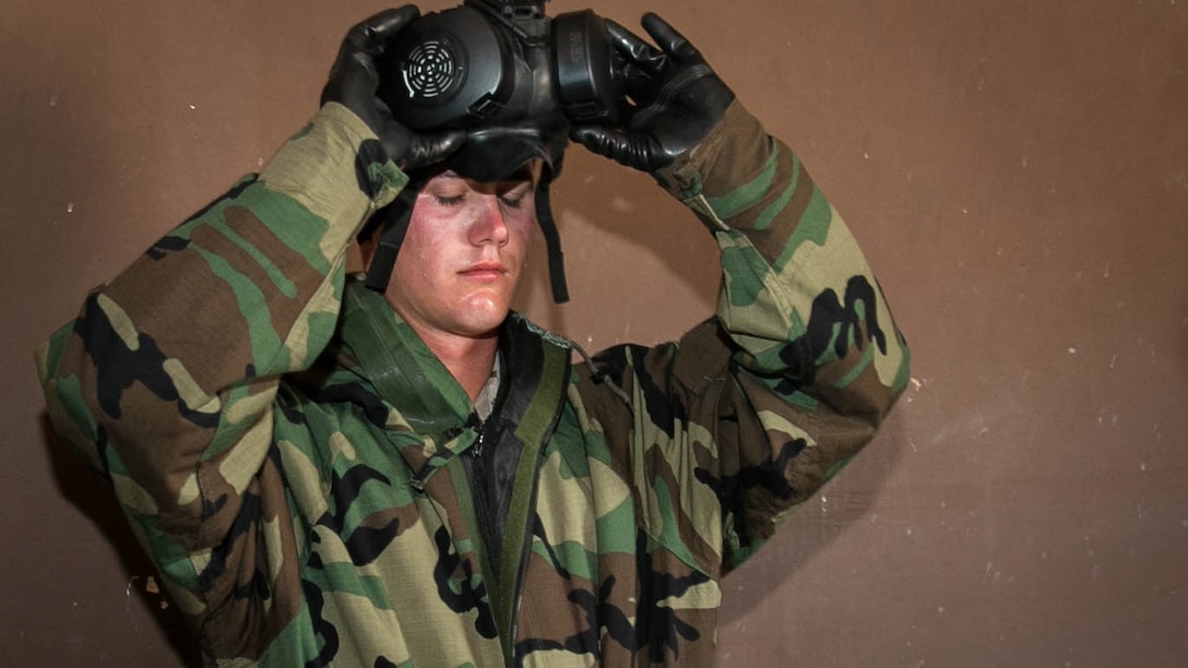 Cpl. Tristofer Ducharme, operator, Unmanned Aerial Vehicle Squadron 1, removes his M50 joint service general purpose mask during annual training in the confidence chamber at Range 105, Aug. 27, 2015. While inside the chamber the Marines are required to perform exercises to ensure the mask is properly sealed. 
