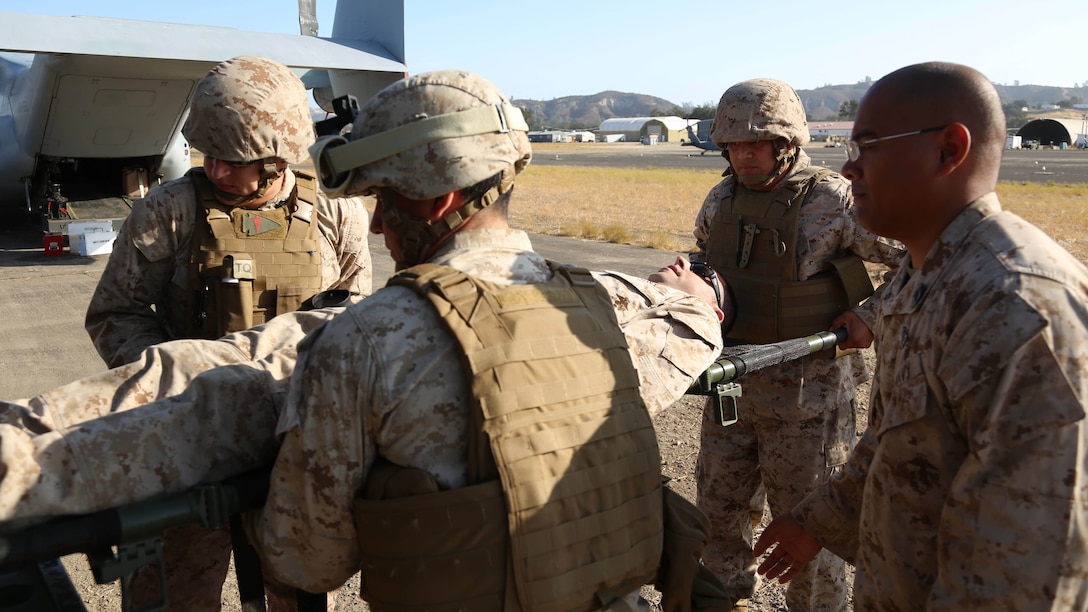 U.S. Navy Corpsmen with Shock Trauma Platoon, Combat Logistics Battalion 13, the logistics combat element for the 13th Marine Expeditionary Unit, carry a simulated casualty on a stretcher to the rear of a medical aid vehicle at Fort Hunter Liggett, California, during training to familiarize medical personnel with attending to casualties arriving on the flight line at Realistic Urban Training (RUT) Exercise, Sept. 2, 2015. RUT is the final ground-based training requirement prior to deployment as the 13th MEU moves toward operating embarked at sea. 