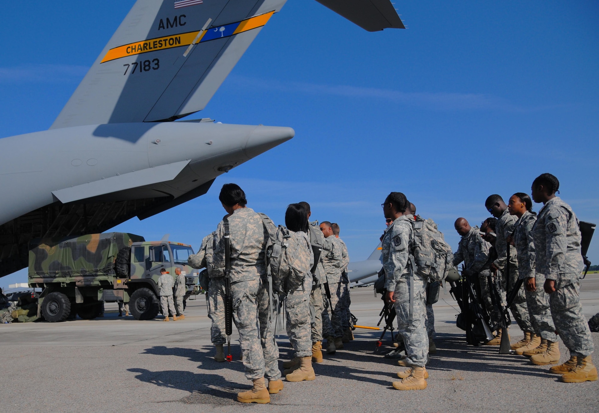 Soldiers of the 414th Chemical Brigade load an Air Force Reserve Boeing C-17 Globe master III of the 315th Air Wing in Charleston, S.C., for transport to Fort McCoy, Wis., Aug. 15, 2015, in support of Operation Red Dragon. Red Dragon is a Civil Defense readiness exercise, which incorporates Army Reserve and National Guard Soldiers with civilian first responder agencies such as fire departments, police departments and hospitals to improve capabilities in large-scale chemical defense operations. (U.S. Army photo by Sgt. Eben Boothby)