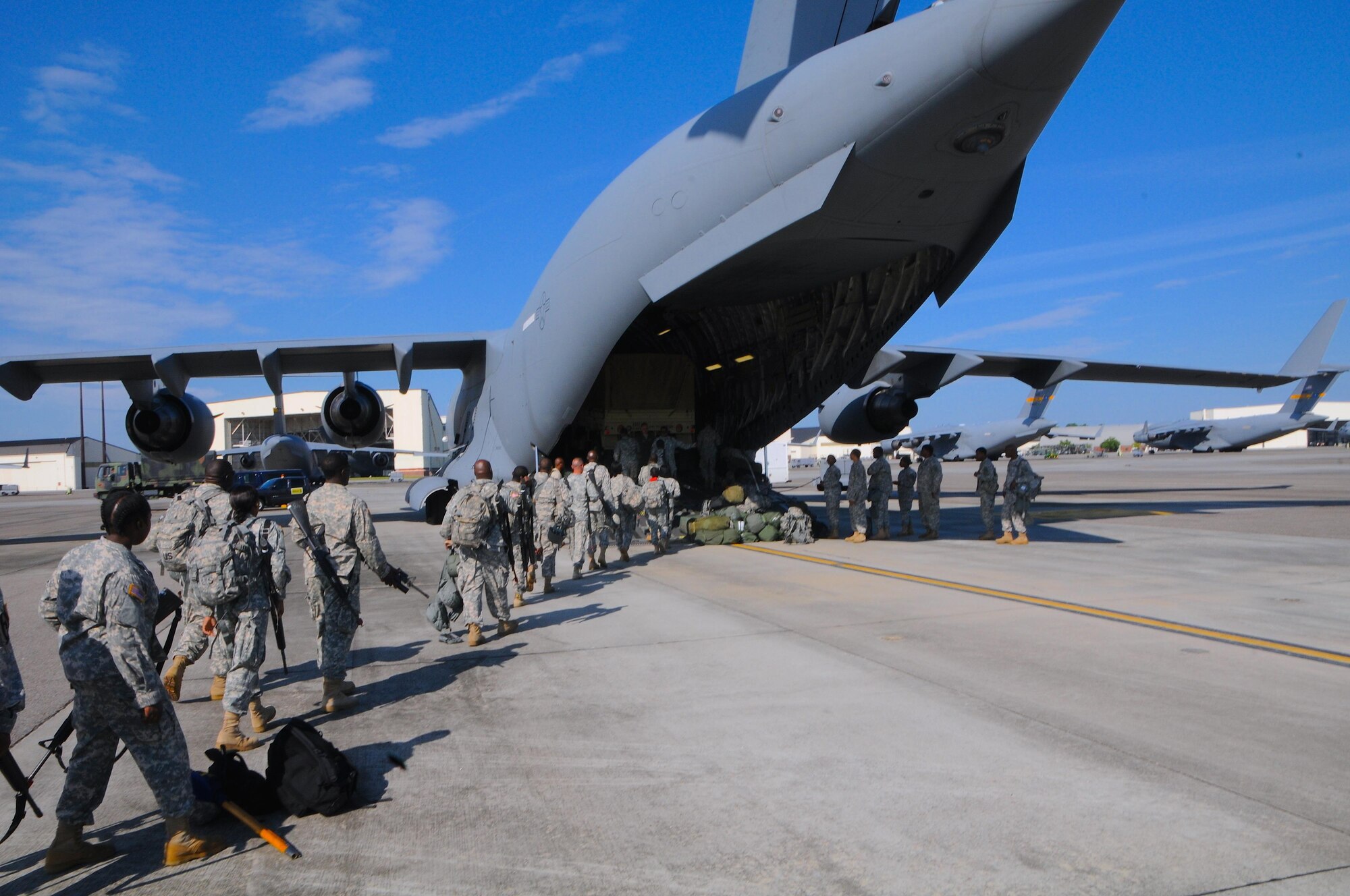 Soldiers of the 414th Chemical Brigade load an Air Force Reserve Boeing C-17 Globe master III of the 315th Air Wing in Charleston, S.C., for transport to Fort McCoy, WI on Aug. 15, 2015, in support of Operation Red Dragon. Red Dragon is a Civil Defense readiness exercise, which incorporates Army Reserve and National Guard Soldiers with civilian first responder agencies such as fire departments, police departments and hospitals to improve capabilities in large-scale chemical defense operations. (U.S. Army photo by Sgt. Eben Boothby)