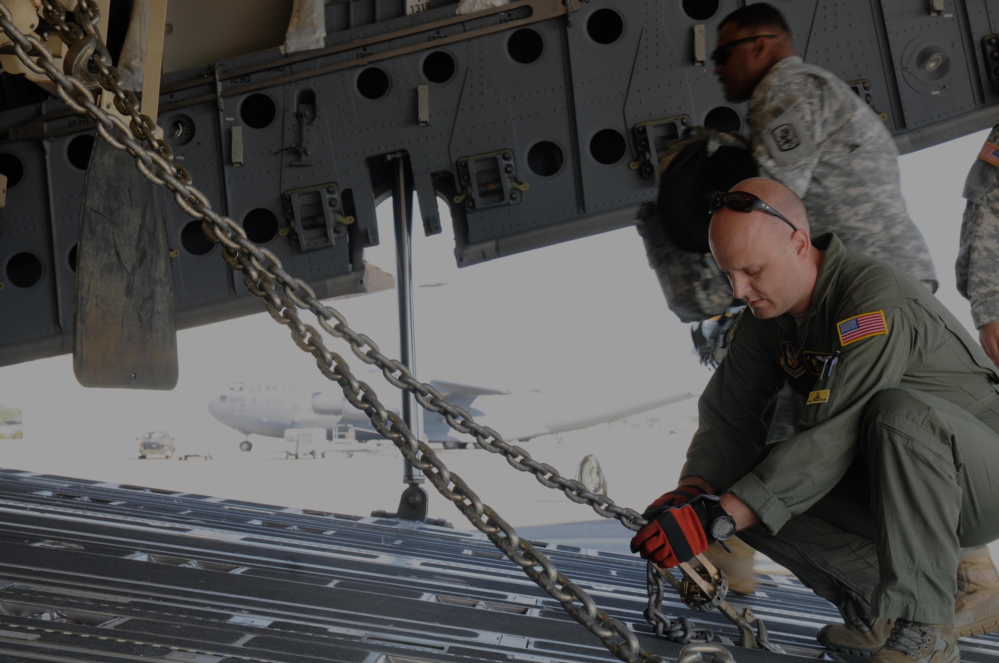 Staff Sgt. Doug Wattier a Loadmaster with the 317th Airlift Squadron based in Charleston, S.C., chains down a Light Medium Tactical Vehicle LMTV into the cargo bay of a Boeing C-17 Globe master on Aug. 15, 2015, in support of Operation Red Dragon. Red Dragon is a Civil Defense readiness exercise incorporating Army Reserve and National Guard Soldiers with civilian first responder agencies such as fire departments, police departments and hospitals to improve capabilities in large-scale chemical defense operations. (U.S. Army photo by Sgt. Eben Boothby)