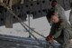 Staff Sgt. Doug Wattier a Loadmaster with the 317th Airlift Squadron based in Charleston, S.C., chains down a Light Medium Tactical Vehicle LMTV into the cargo bay of a Boeing C-17 Globe master on Aug. 15, 2015, in support of Operation Red Dragon. Red Dragon is a Civil Defense readiness exercise incorporating Army Reserve and National Guard Soldiers with civilian first responder agencies such as fire departments, police departments and hospitals to improve capabilities in large-scale chemical defense operations. (U.S. Army photo by Sgt. Eben Boothby)